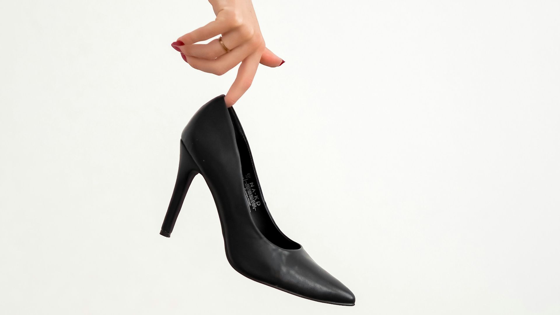 woman in black leather heeled shoes