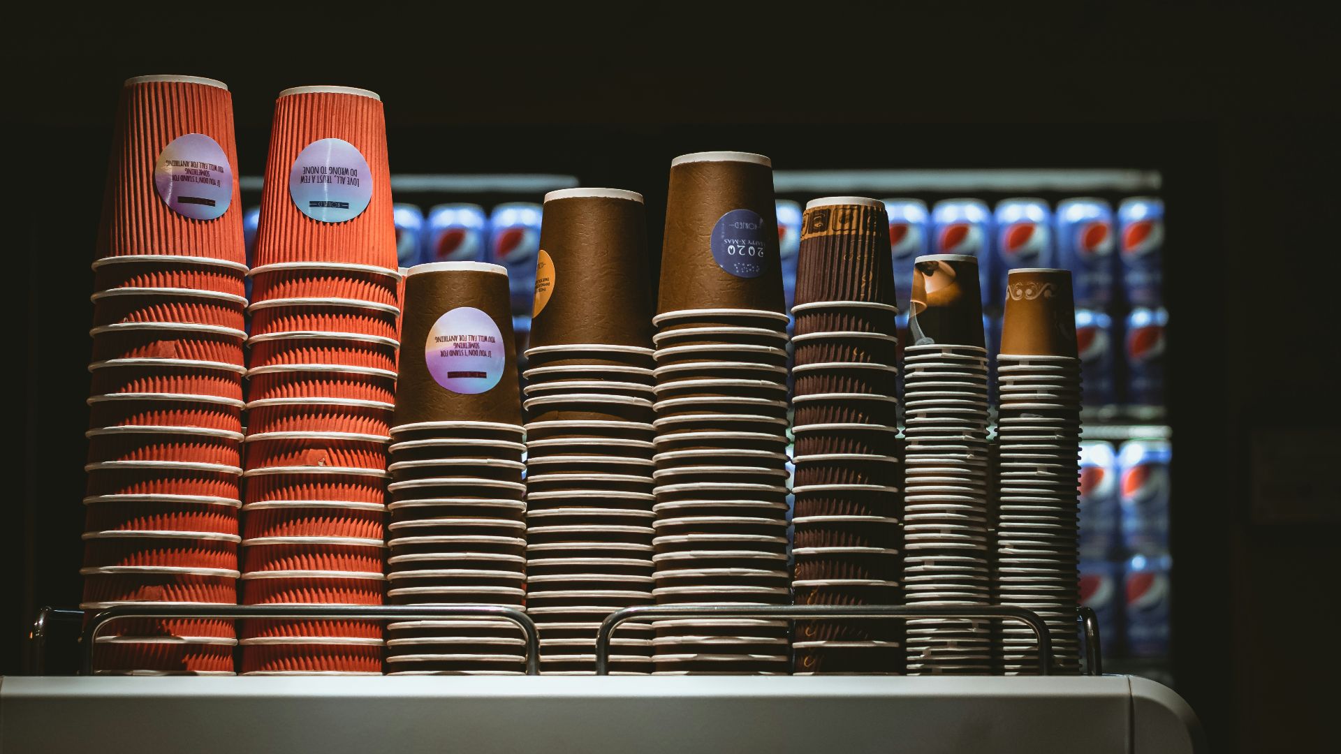 a bunch of cups that are on a shelf