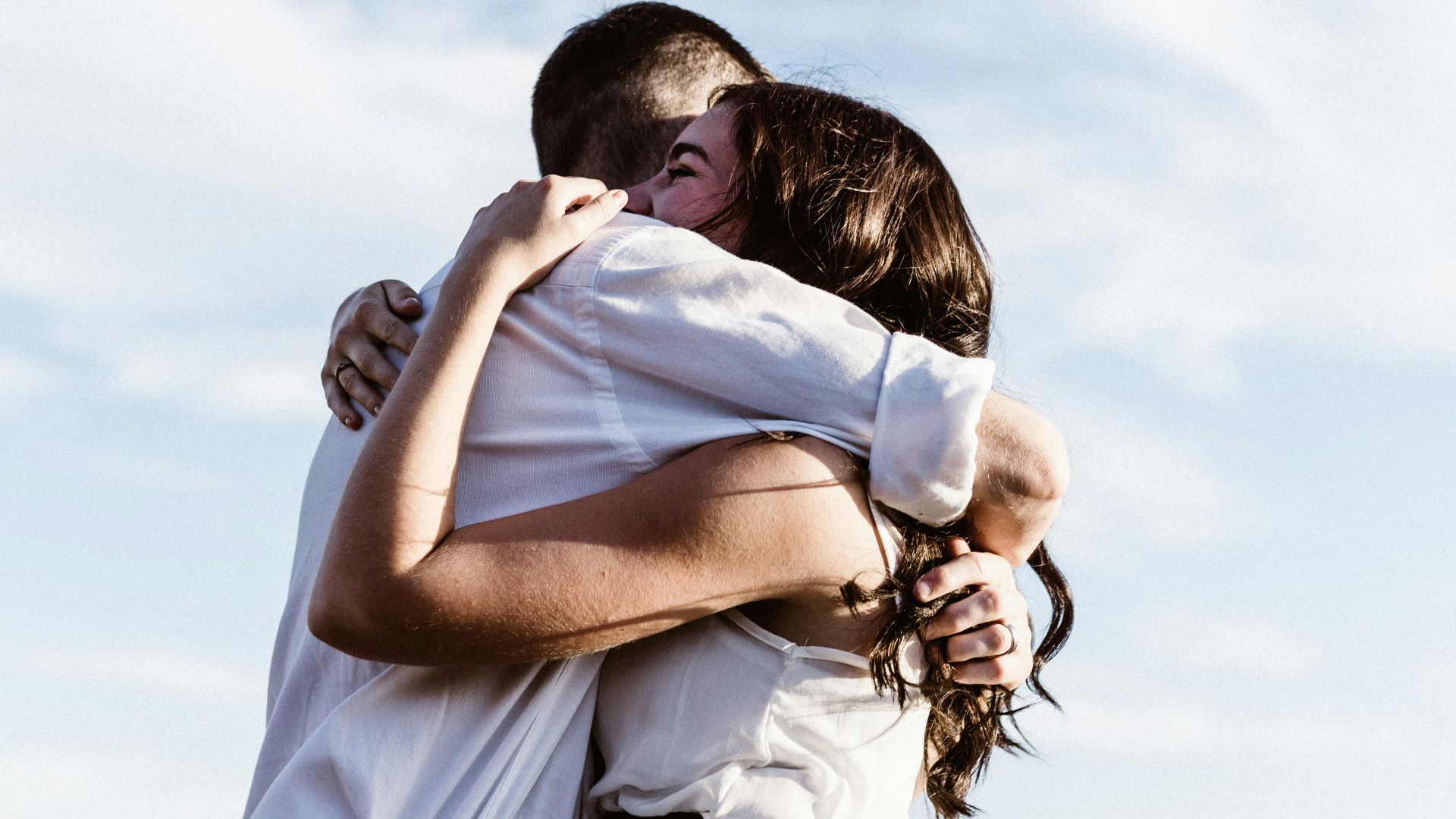 man and woman hugging each other photography