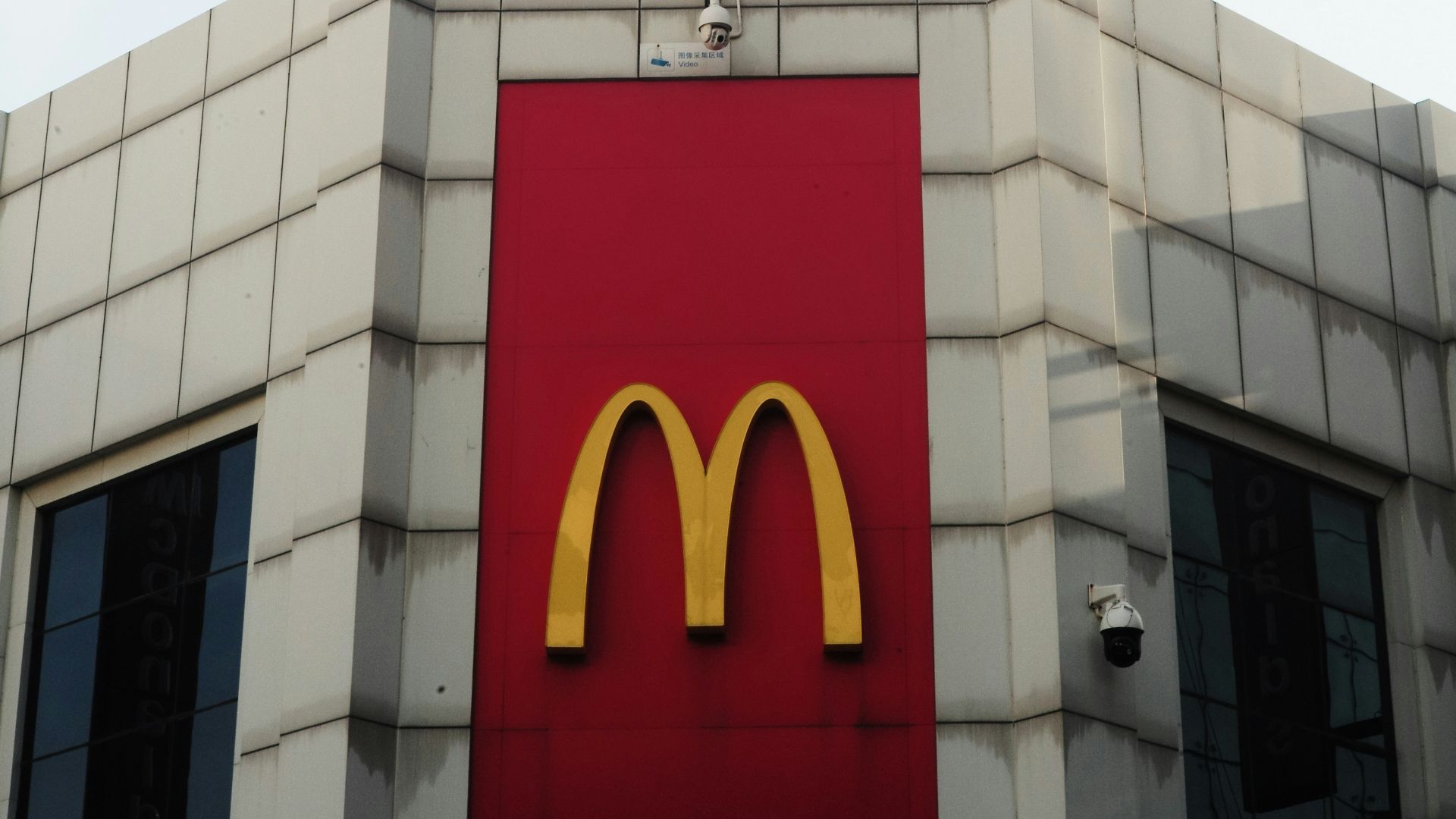 a mcdonald's sign on top of a building