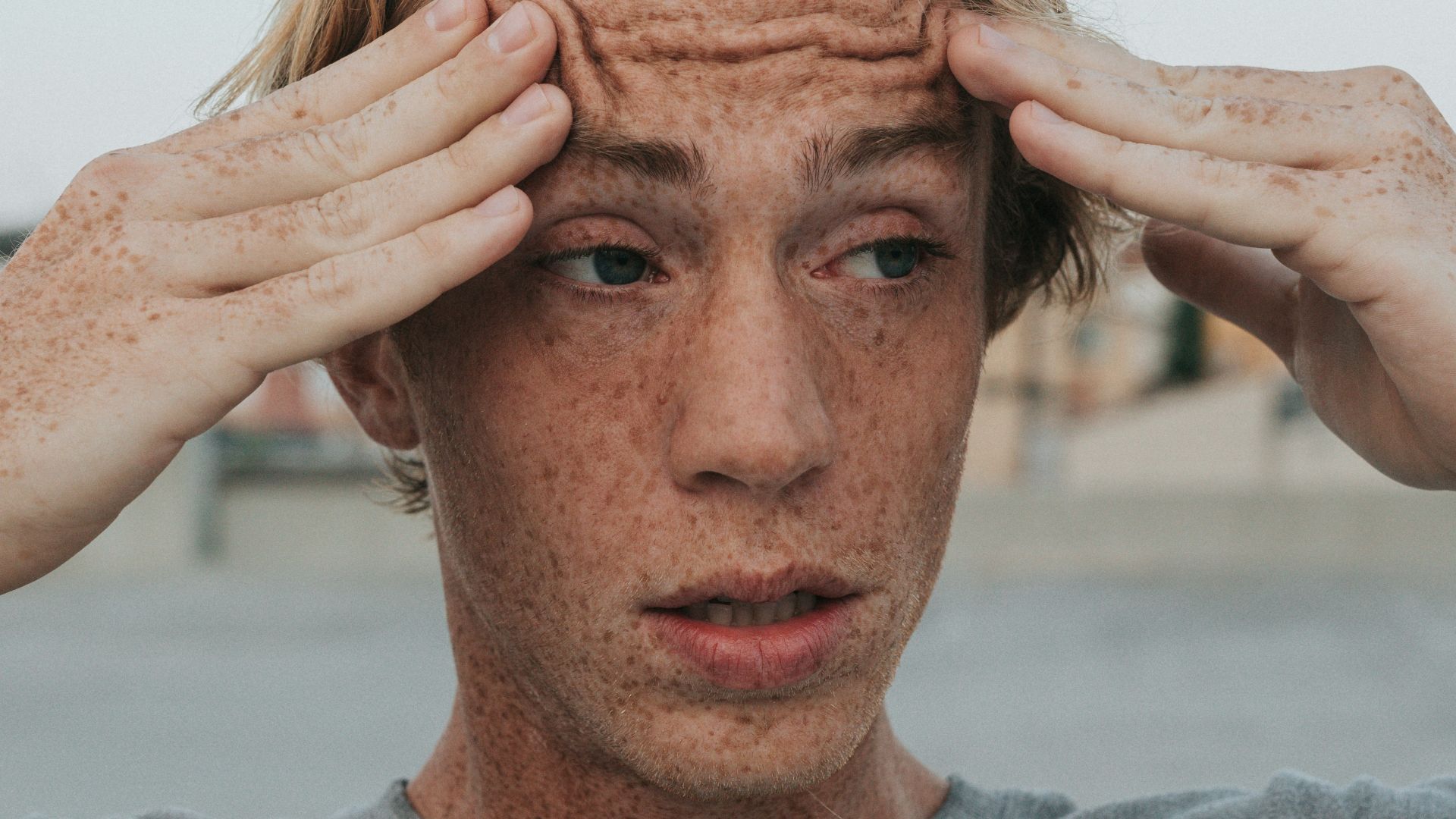 man in gray crew neck shirt with brown hair
