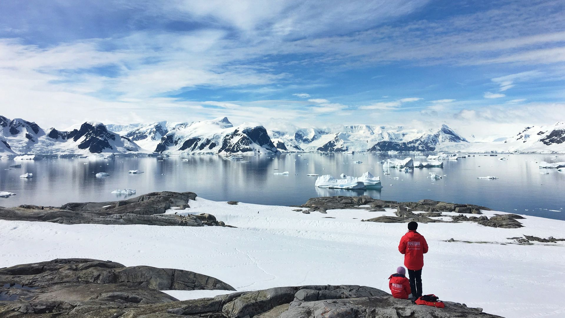 two person standing on snow field