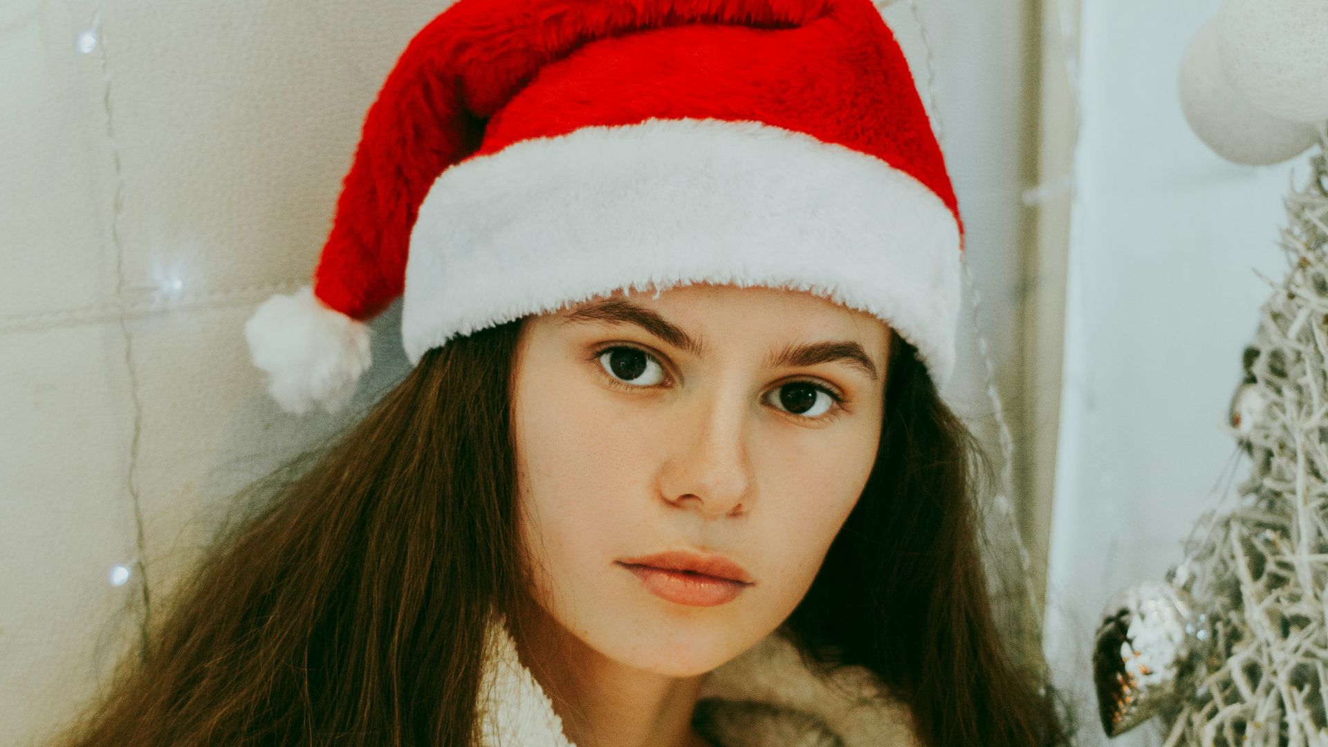 woman holding string lights