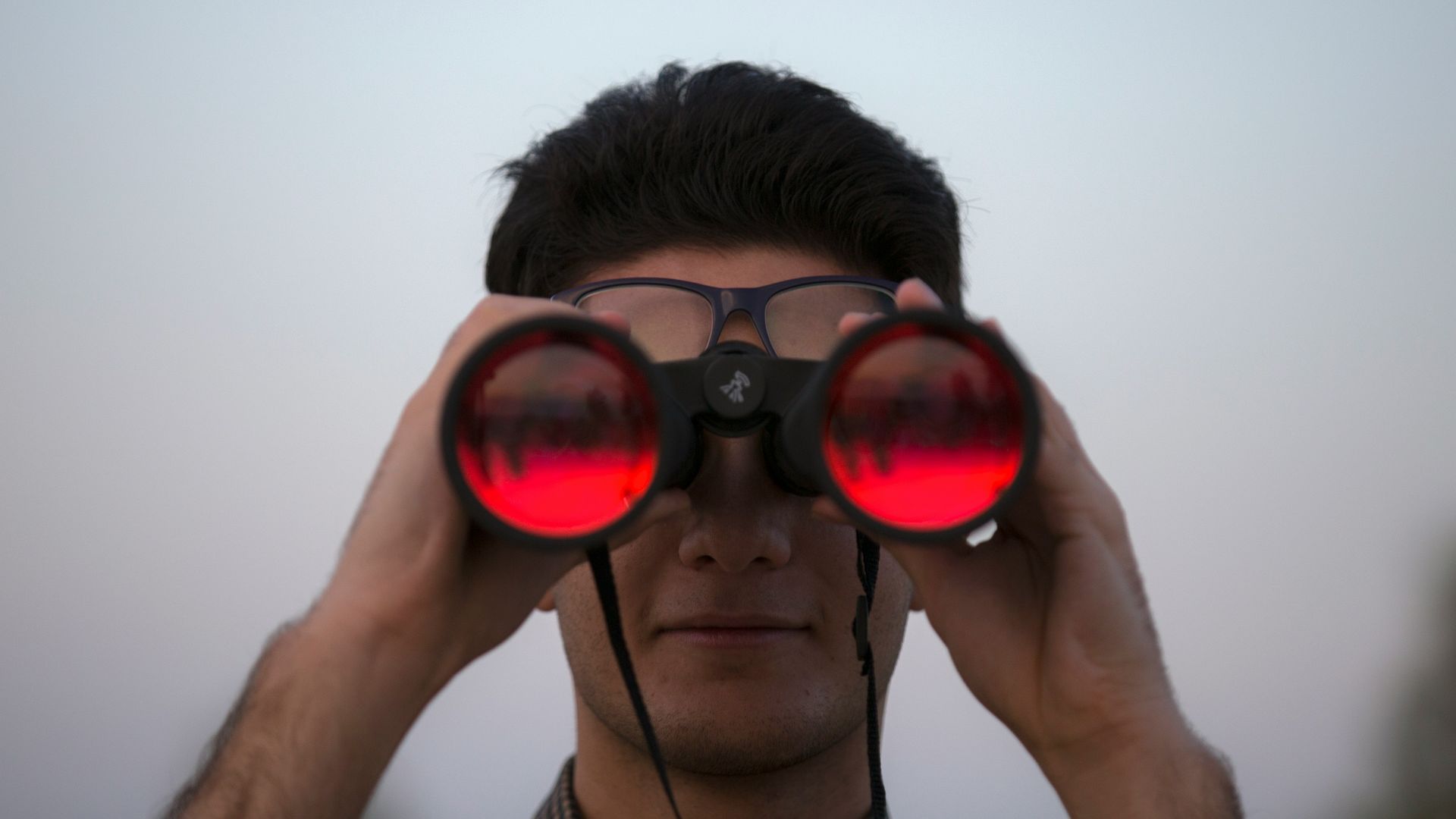 person holding black binoculars