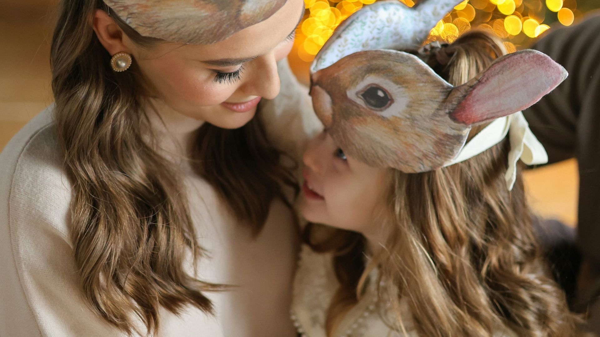 A woman and a child wearing bunny ears