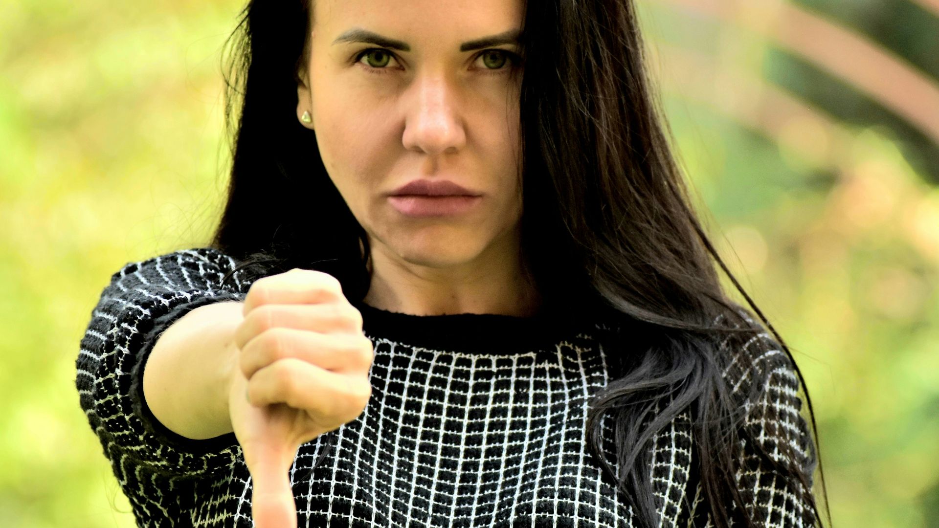 A woman pointing a gun at the camera