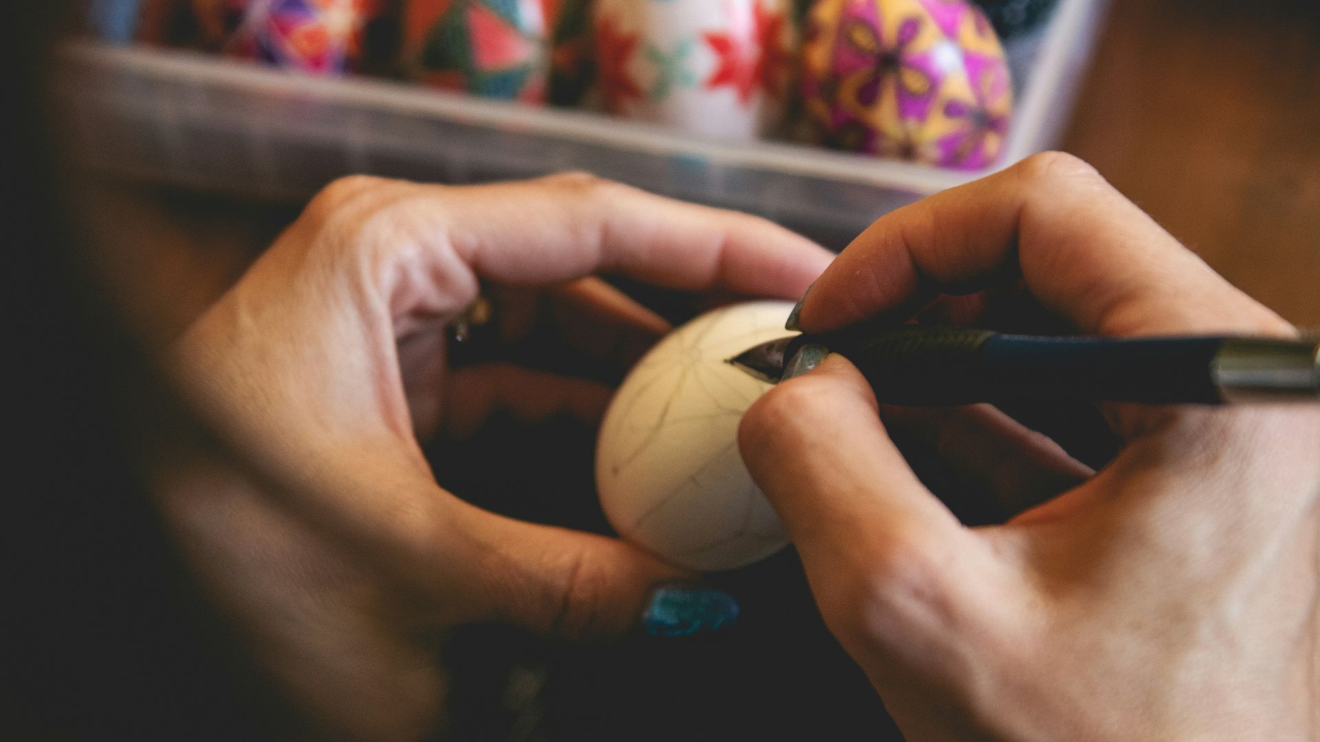 a person is using a marker to draw on some easter eggs