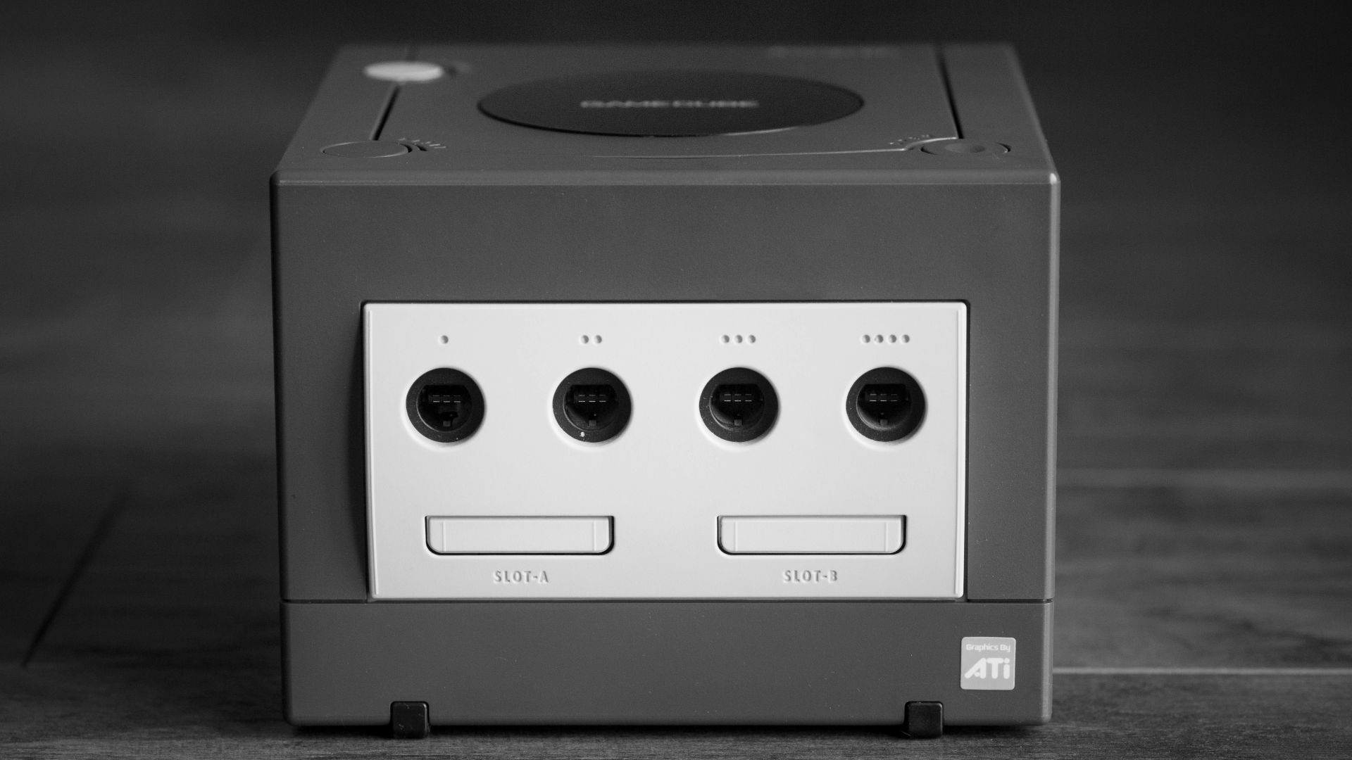 white and black Nintendo GameCube on gray surface