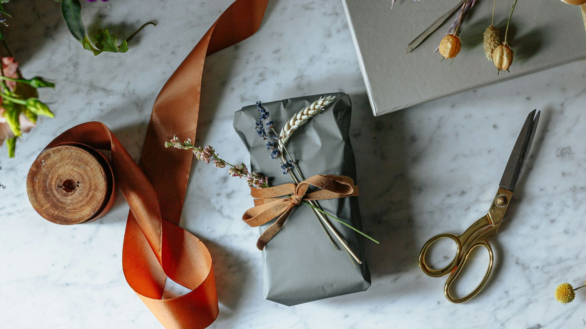 silver scissors beside orange leather shoe