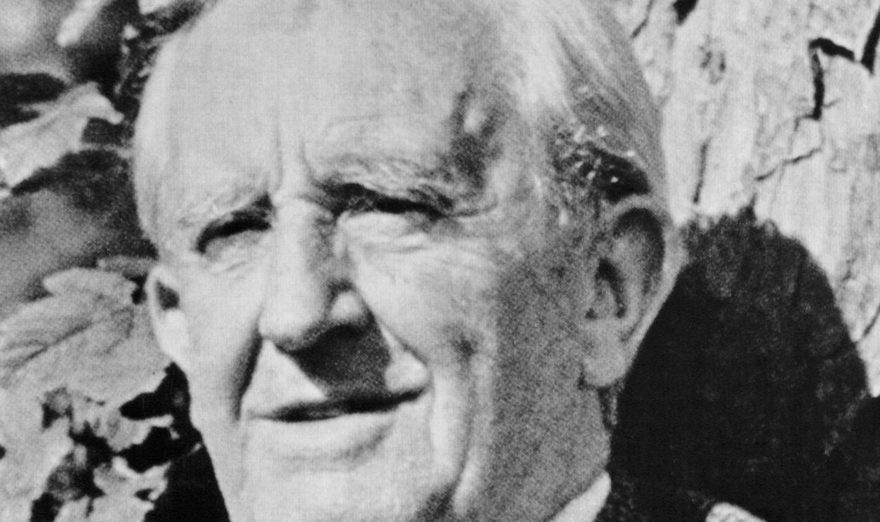 Novelist and professor J.R.R. Tolkien sits against a tree. He was the author of The Lord of the Rings and The Hobbit.