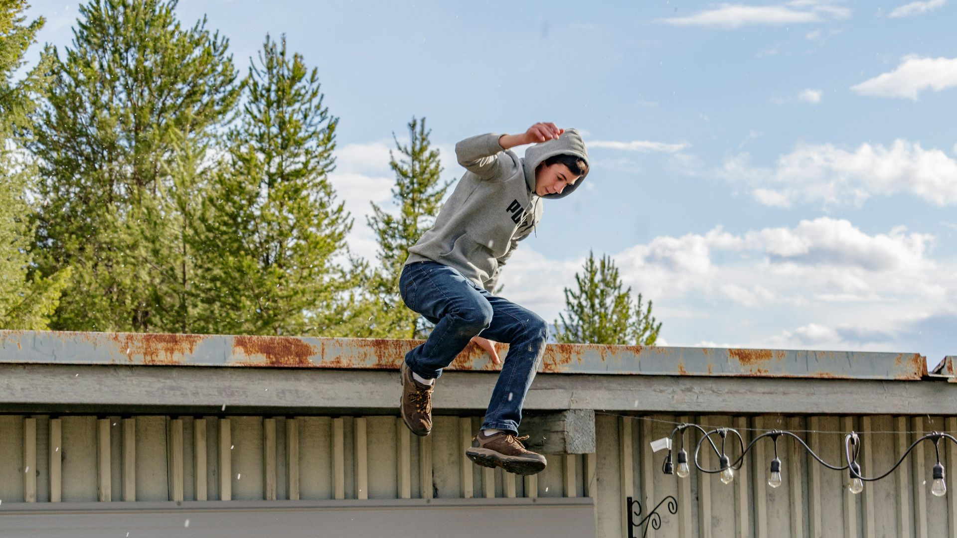 a man jumping on a roof