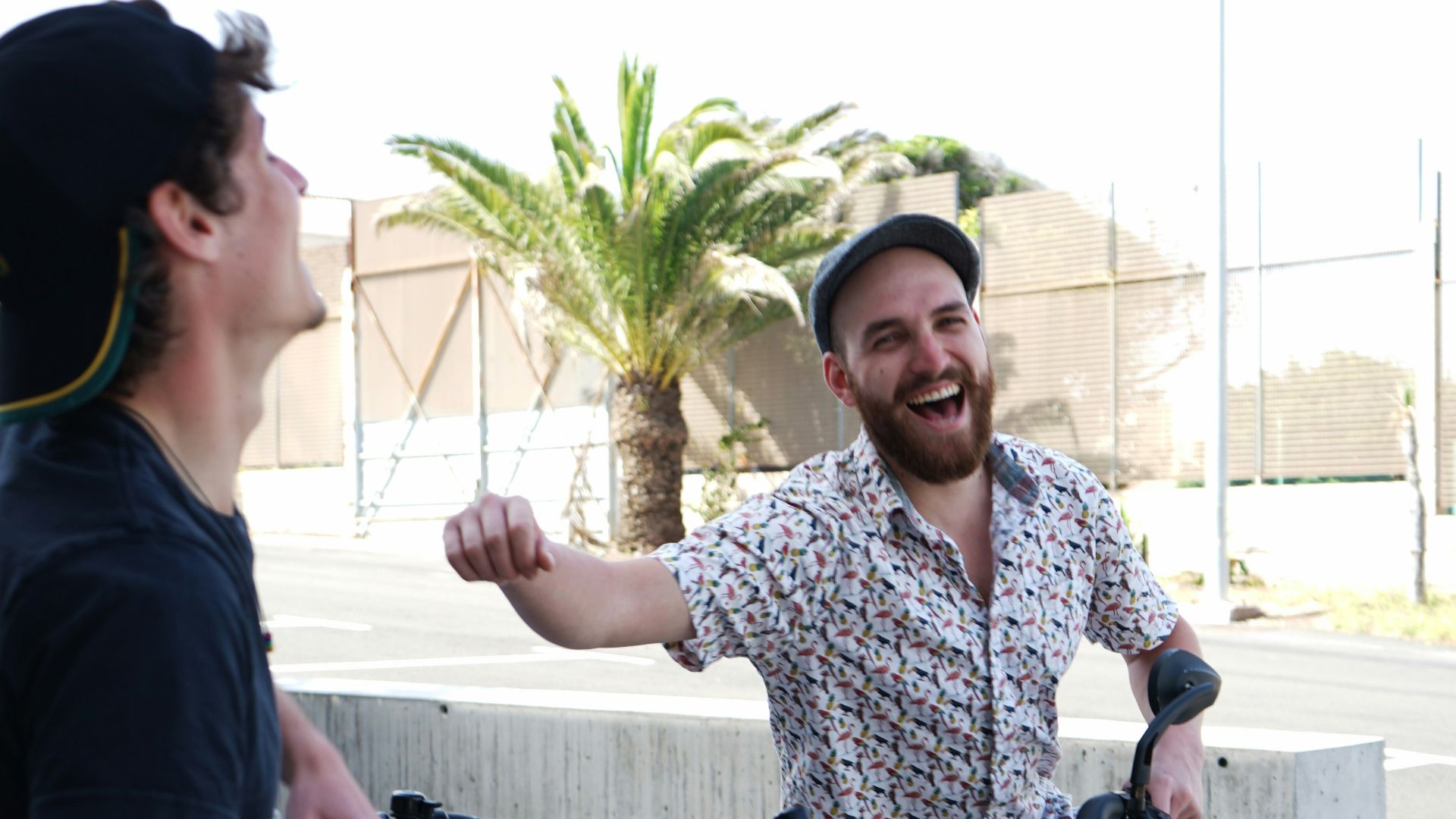 man in blue crew neck t-shirt standing beside woman in white and blue floral shirt