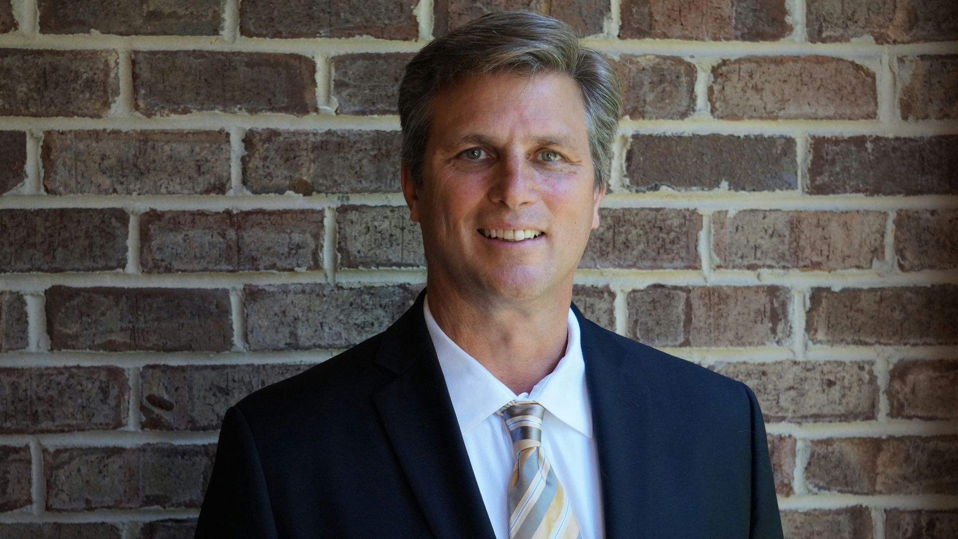 portrait photography of man wearing black suit jacket