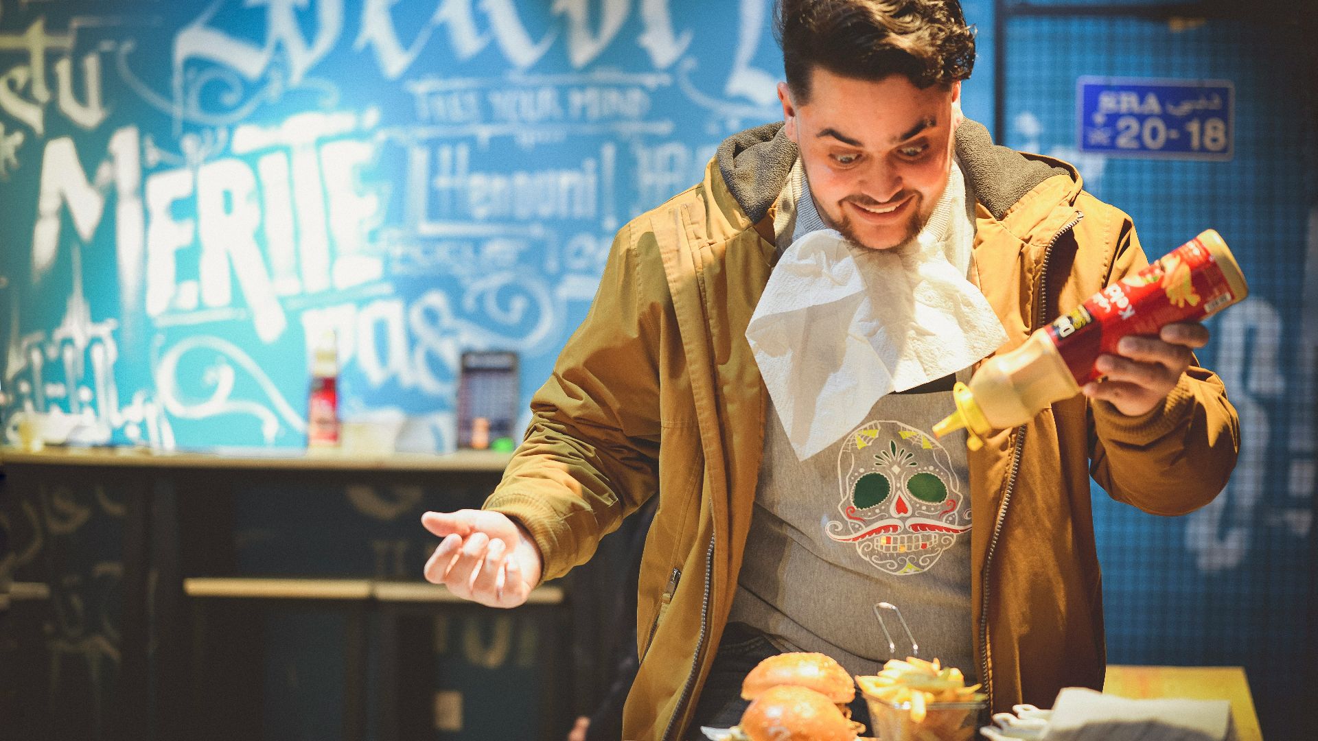 man in brown leather jacket holding white plastic bag