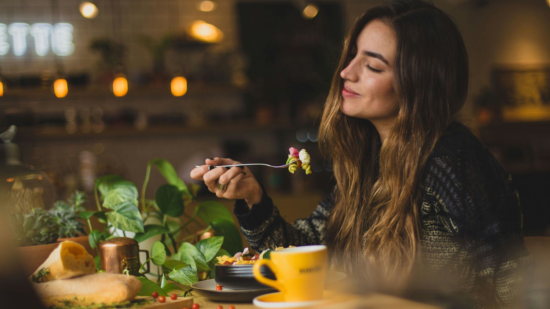 woman holding fork in front table