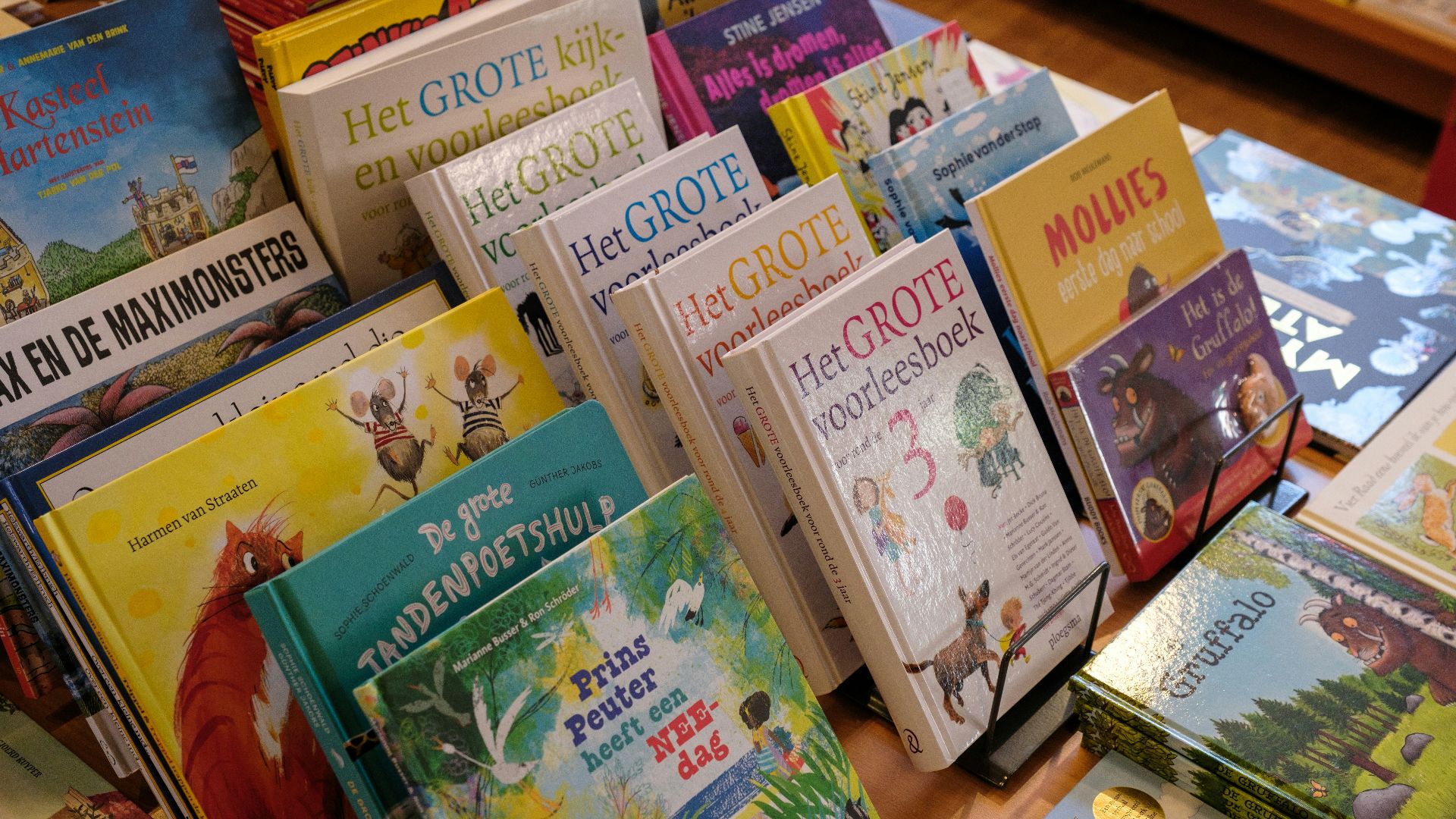 a pile of children's books sitting on top of a table