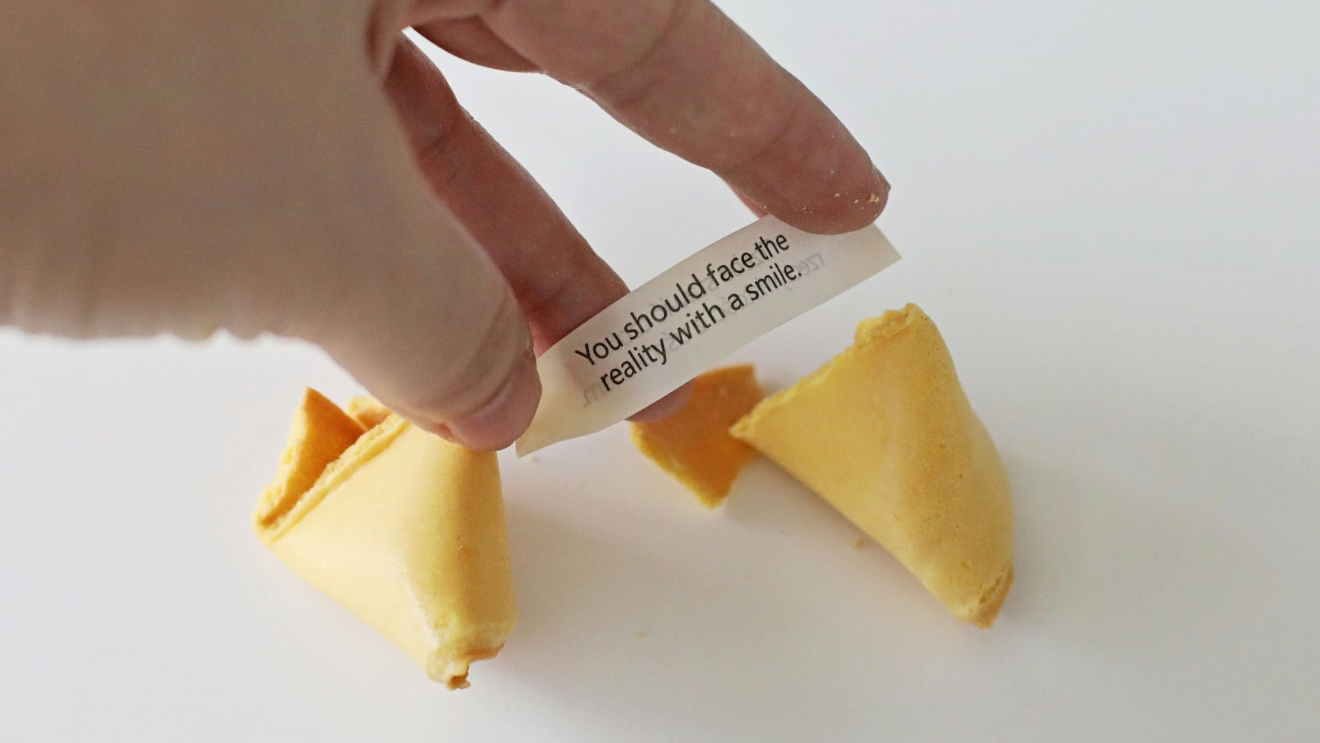 a person is holding a piece of cheese