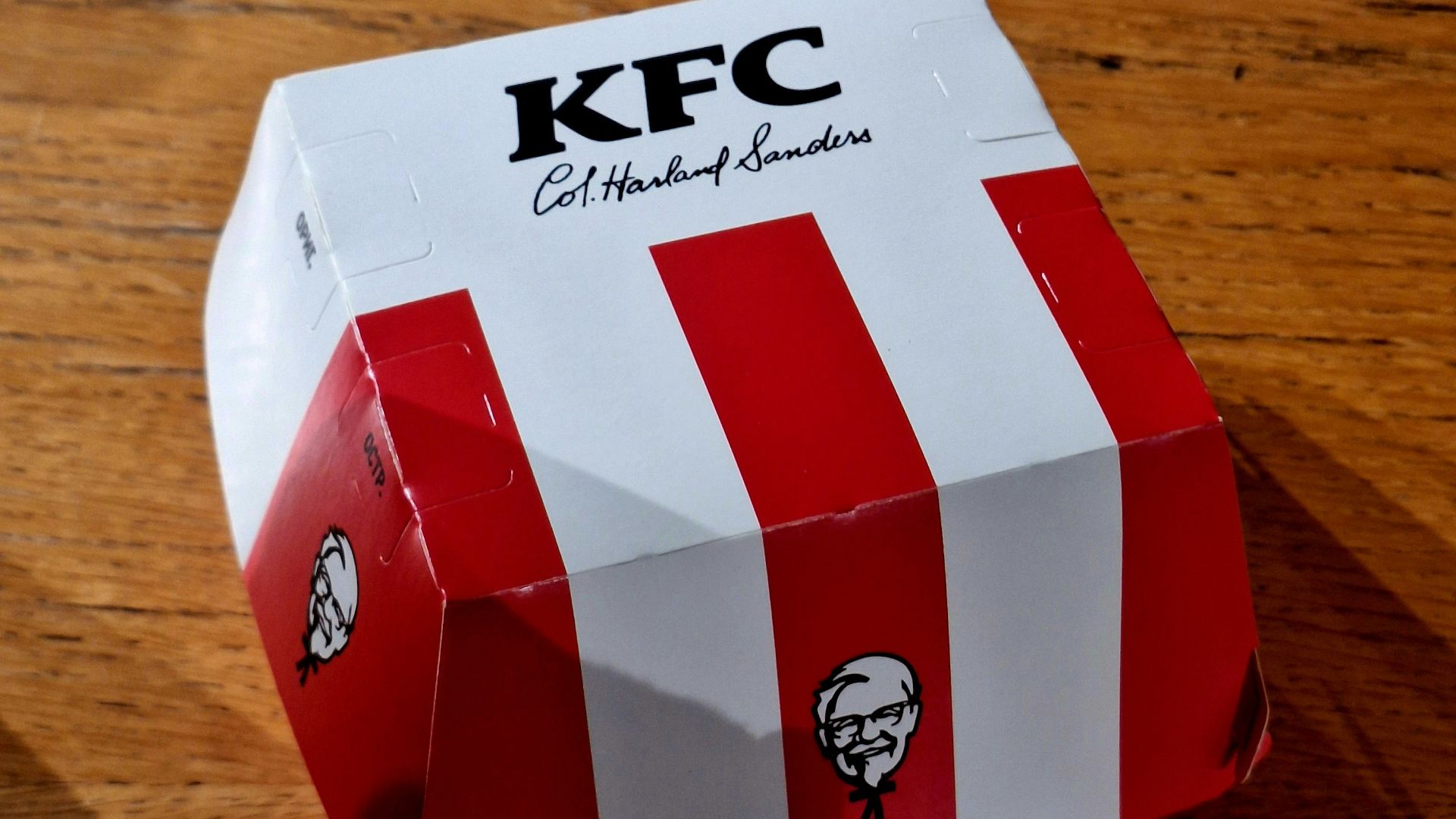 Kfc bucket with red and white stripes on table
