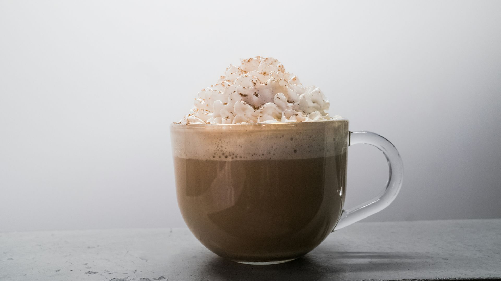 brown ceramic mug with white flower