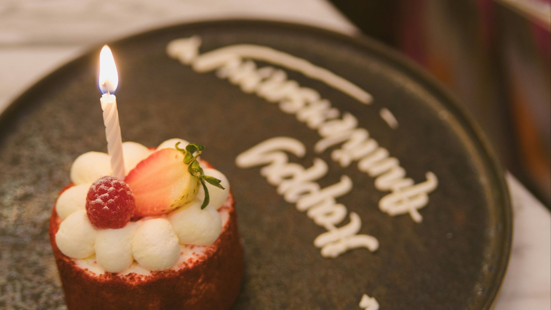 A small cake with a candle on top of it