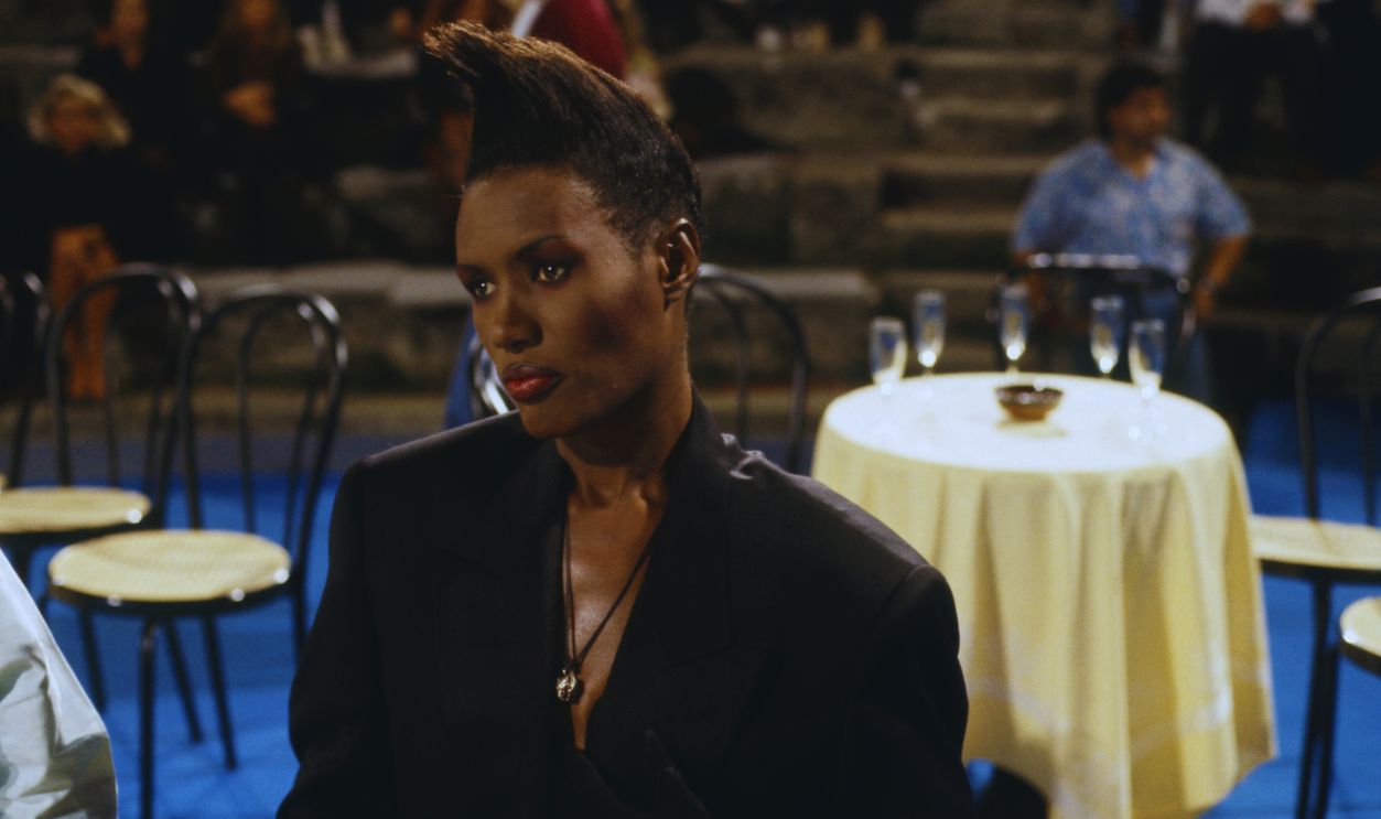 Gettyimages - 471327418, Grace Jones seated at Vota la voce Jamaican singer, model and actress Grace Jones (Grace Mendoza) attending a performance at the music festival Vota la voce. Italy, 1989 