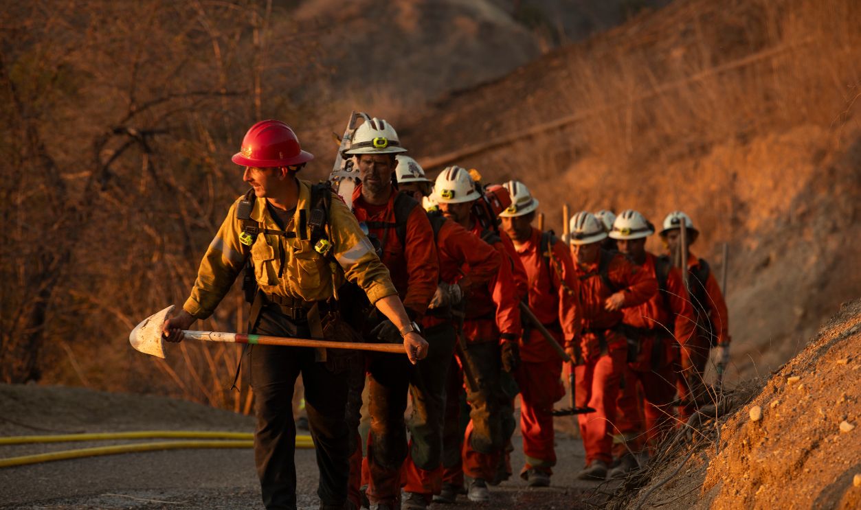Brea, California, USA - October 3, 2021: Incarcerated Firefighters walk on a fire line fighting a wildfire.
