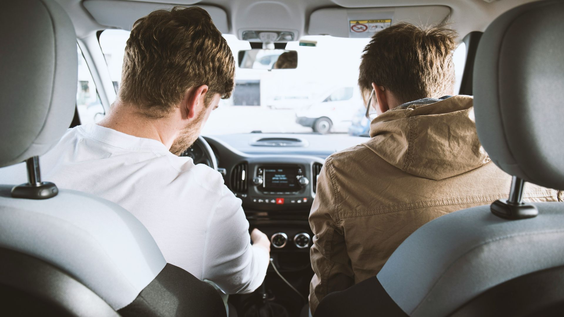 two men sitting inside vehicle