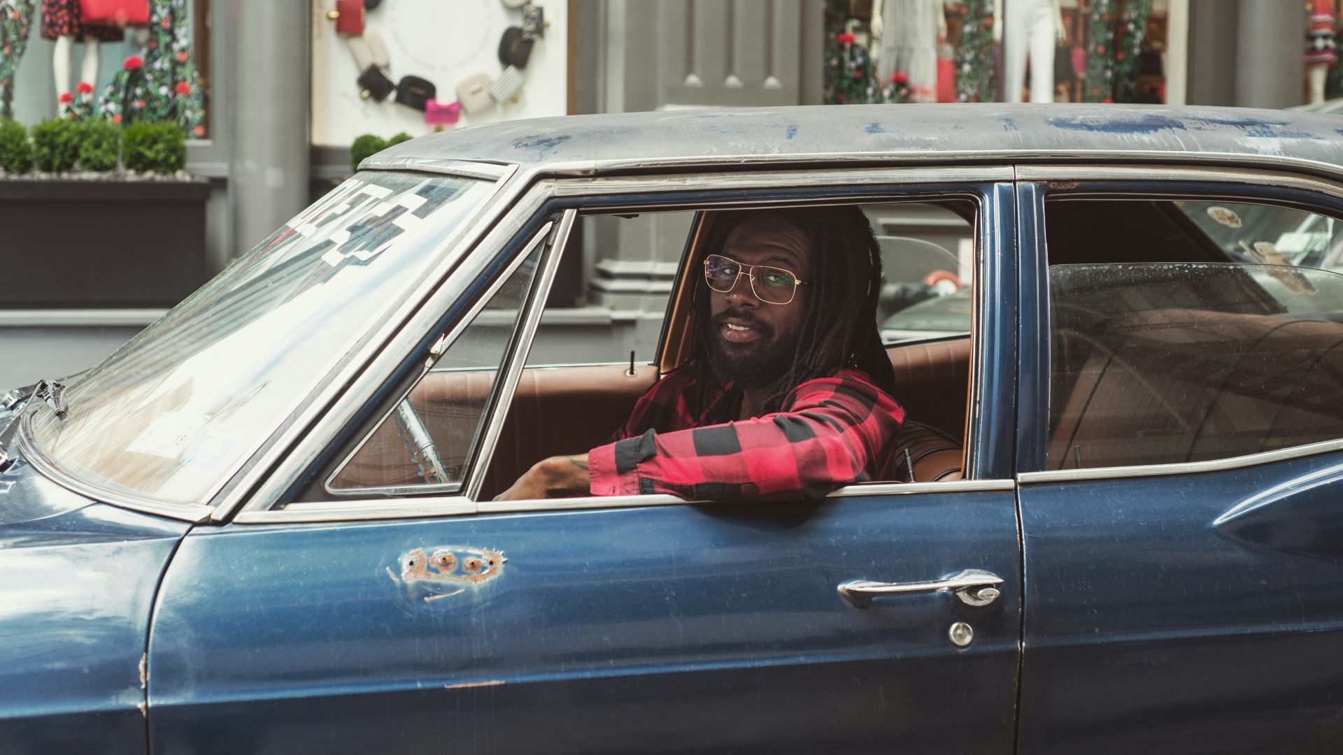 man driving blue car