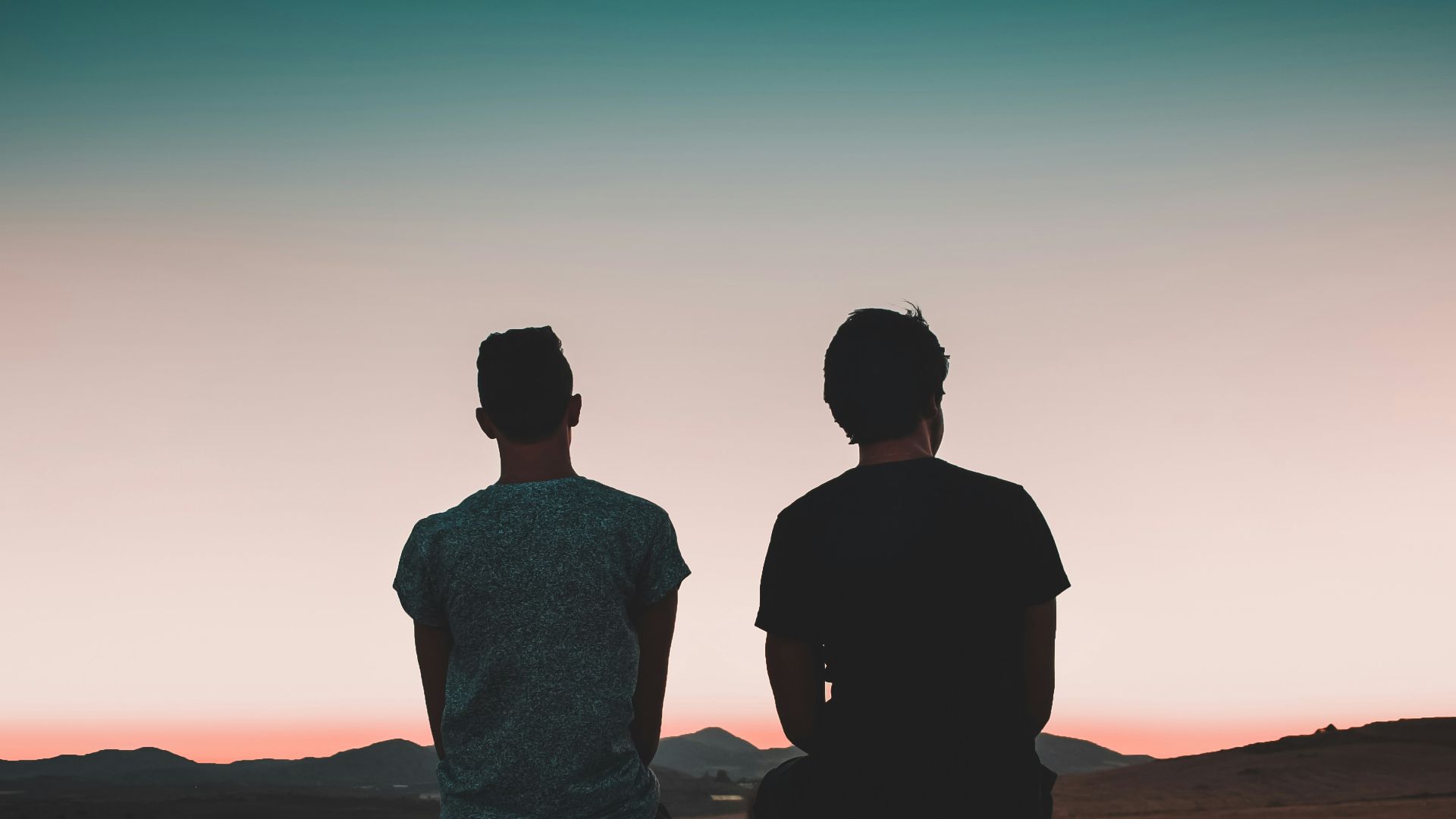 two men sitting on vehicle