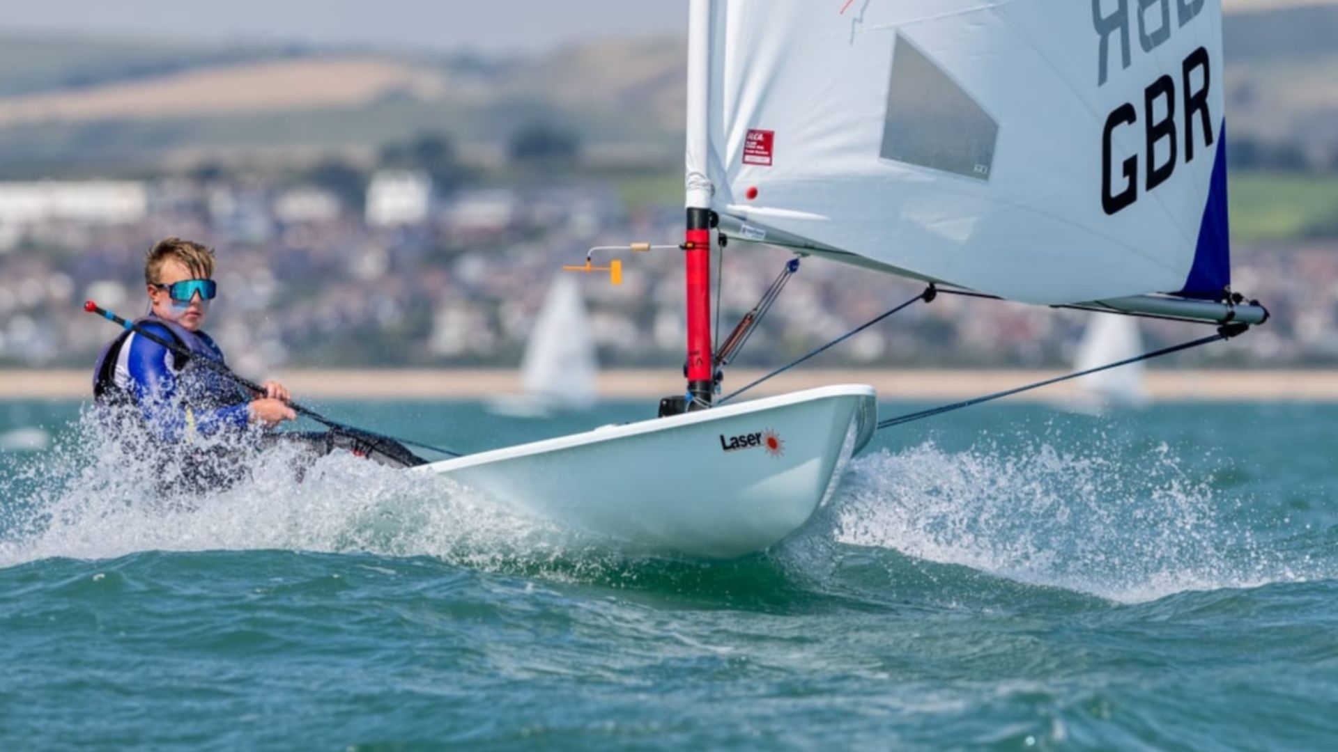 File:GBR ILCA 6 dinghy racing in Waymouth Bay.jpg