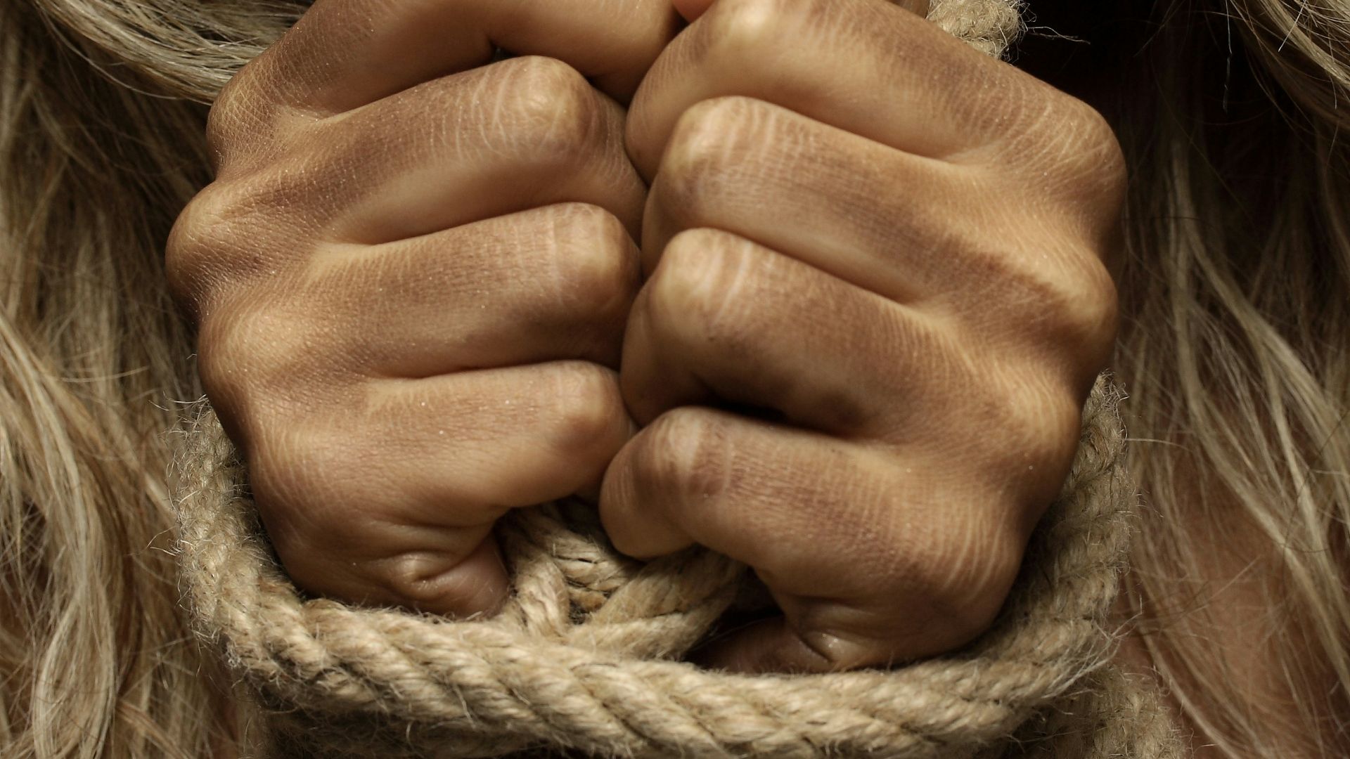 woman with hands tied