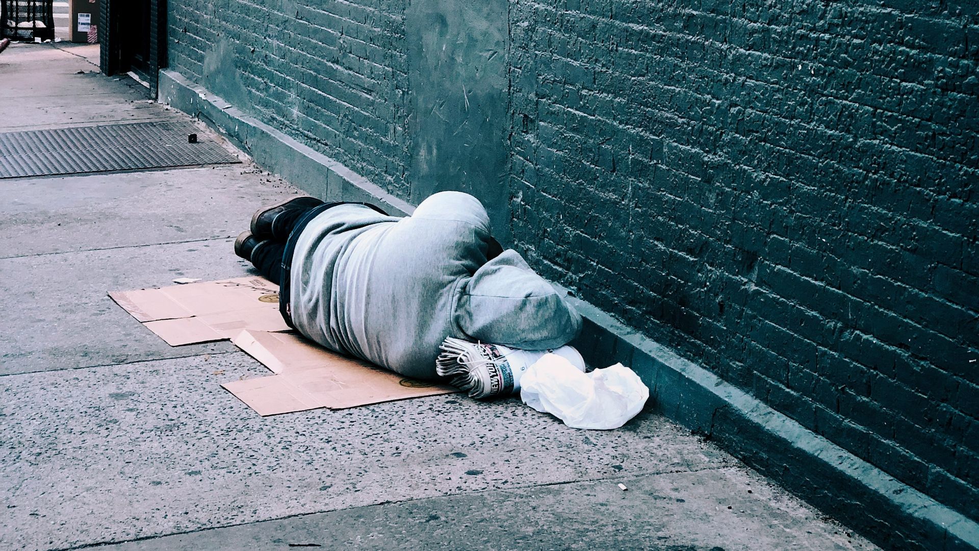 man lying on brown cardboard box
