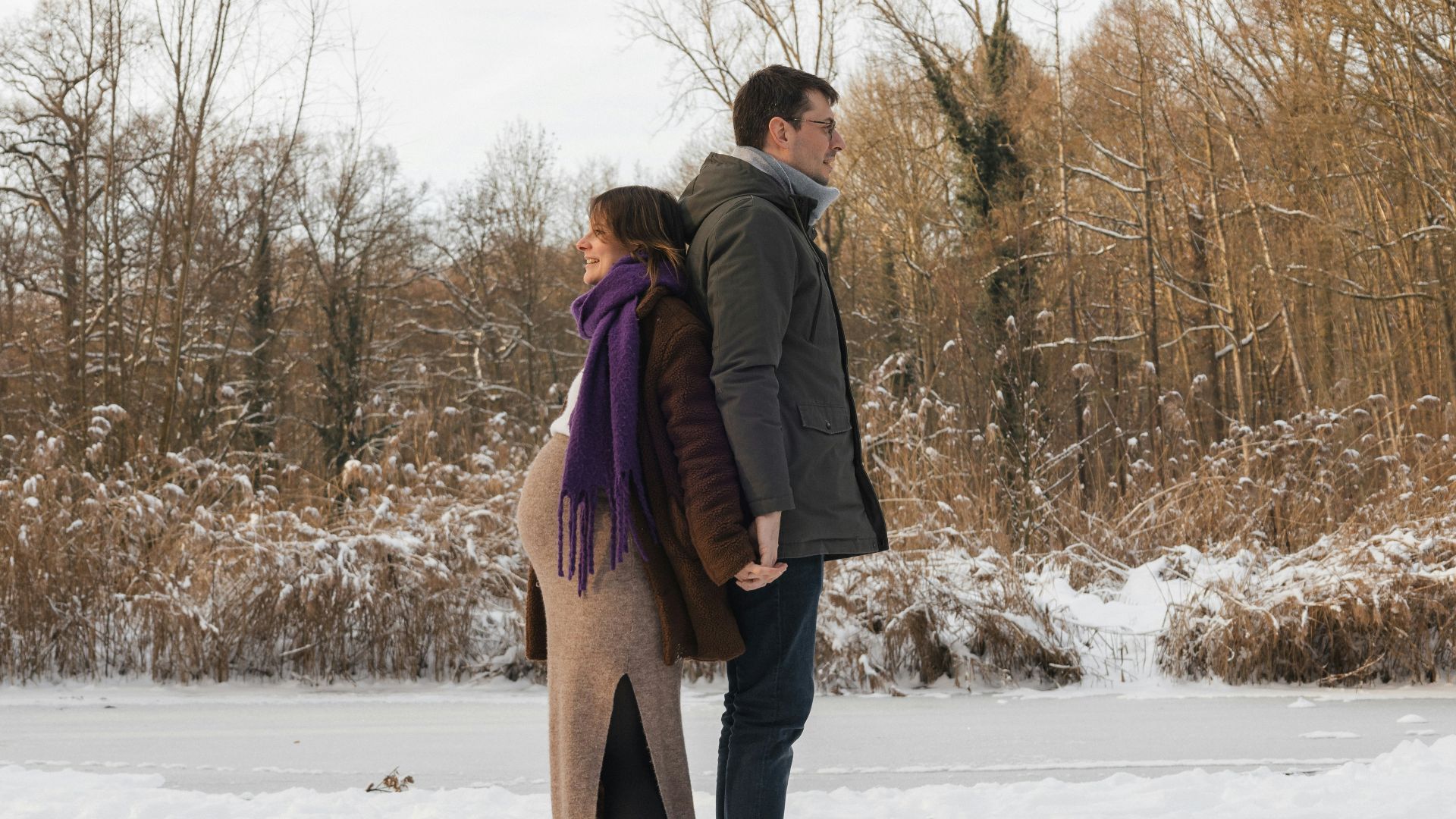 a man and a woman standing in the snow