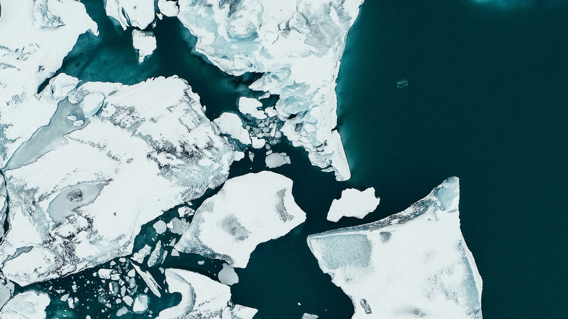 white ice on body of water during daytime