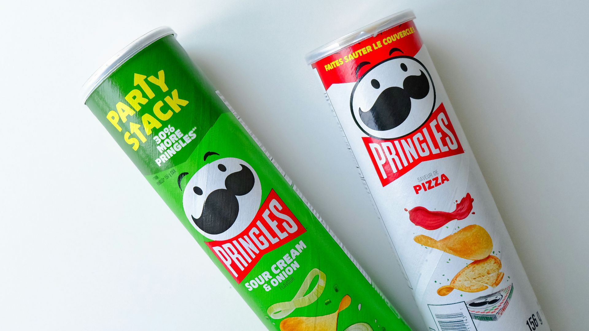 a tube of pringles next to a tube of chips