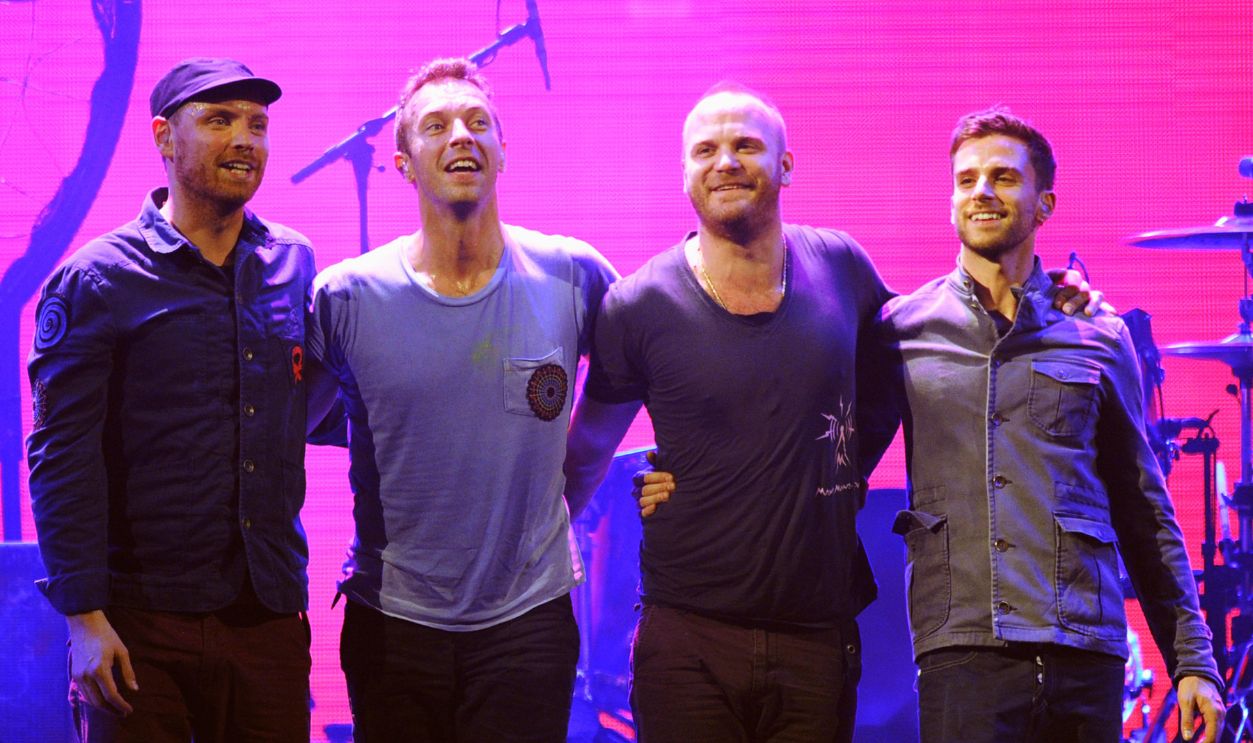 (L-R) Musicians Jonny Buckland, Chris Martin, Will Champion and Guy Berryman of the band Coldplay pose onstage at the iHeartRadio Music Festival held at the MGM Grand Garden Arena on September 23, 2011 in Las Vegas, Nevada.