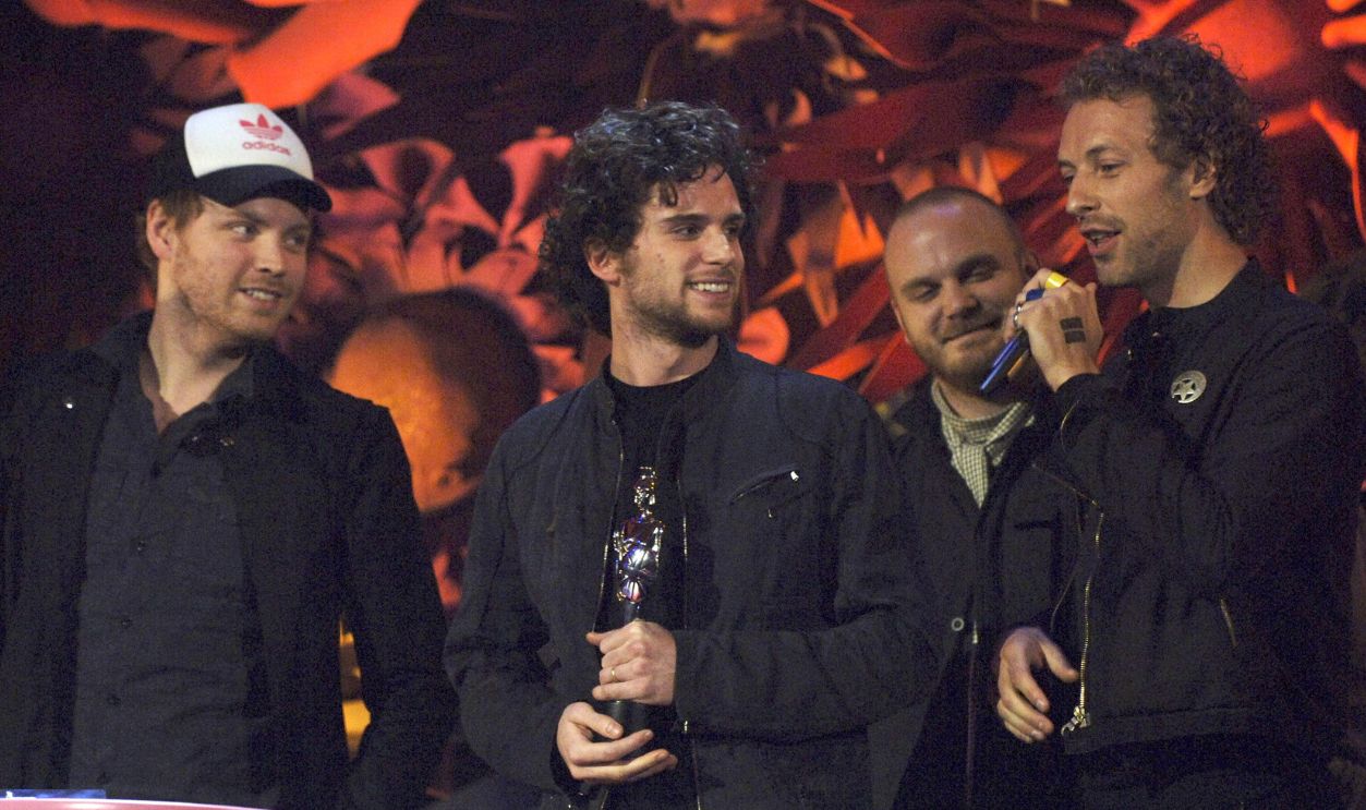 Coldplay (L-R) Guy Berryman, Jonny Buckland and Chris Martin accept the award for British Single on stage at The Brit Awards 2006 with MasterCard at Earls Court 1 on February 15, 2006 in London, England. The 26th annual music awards highlight the achievements of the UK record industry with all proceeds donated to the British Record Industry Trust (BRIT).