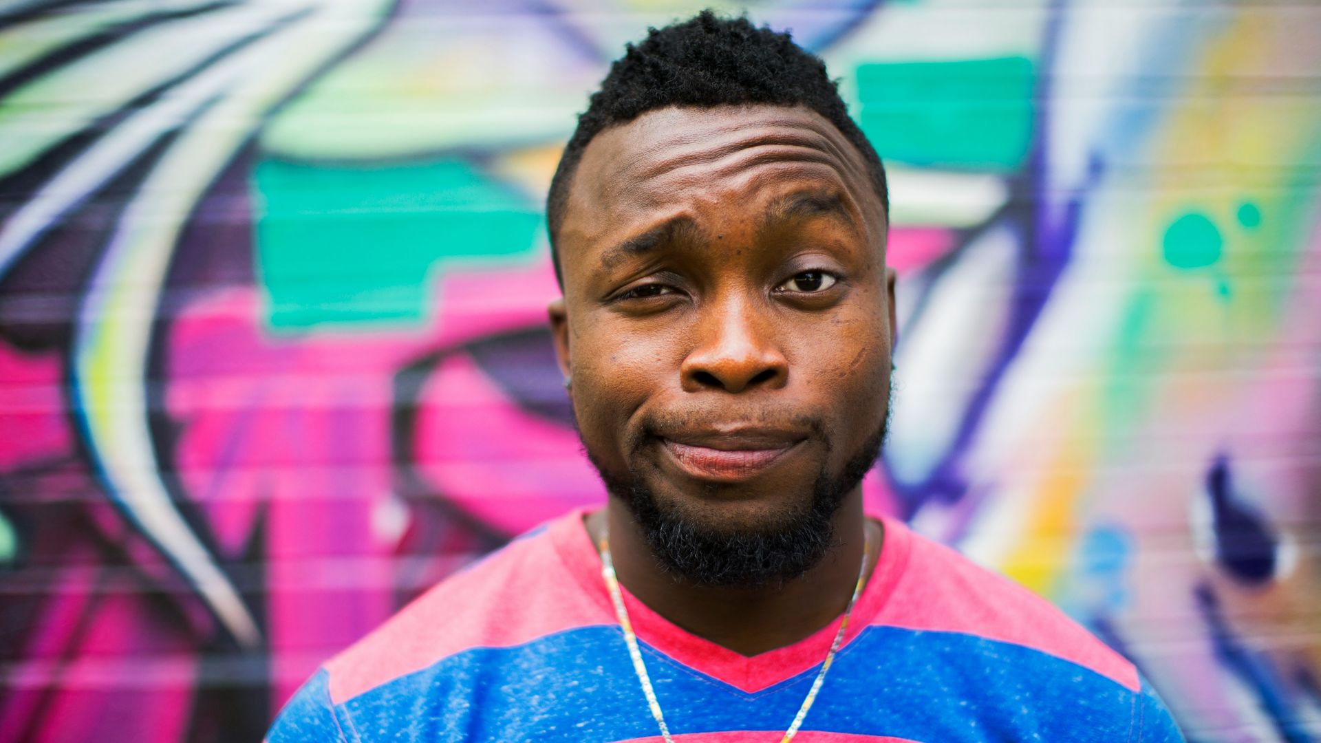 black haired man making face