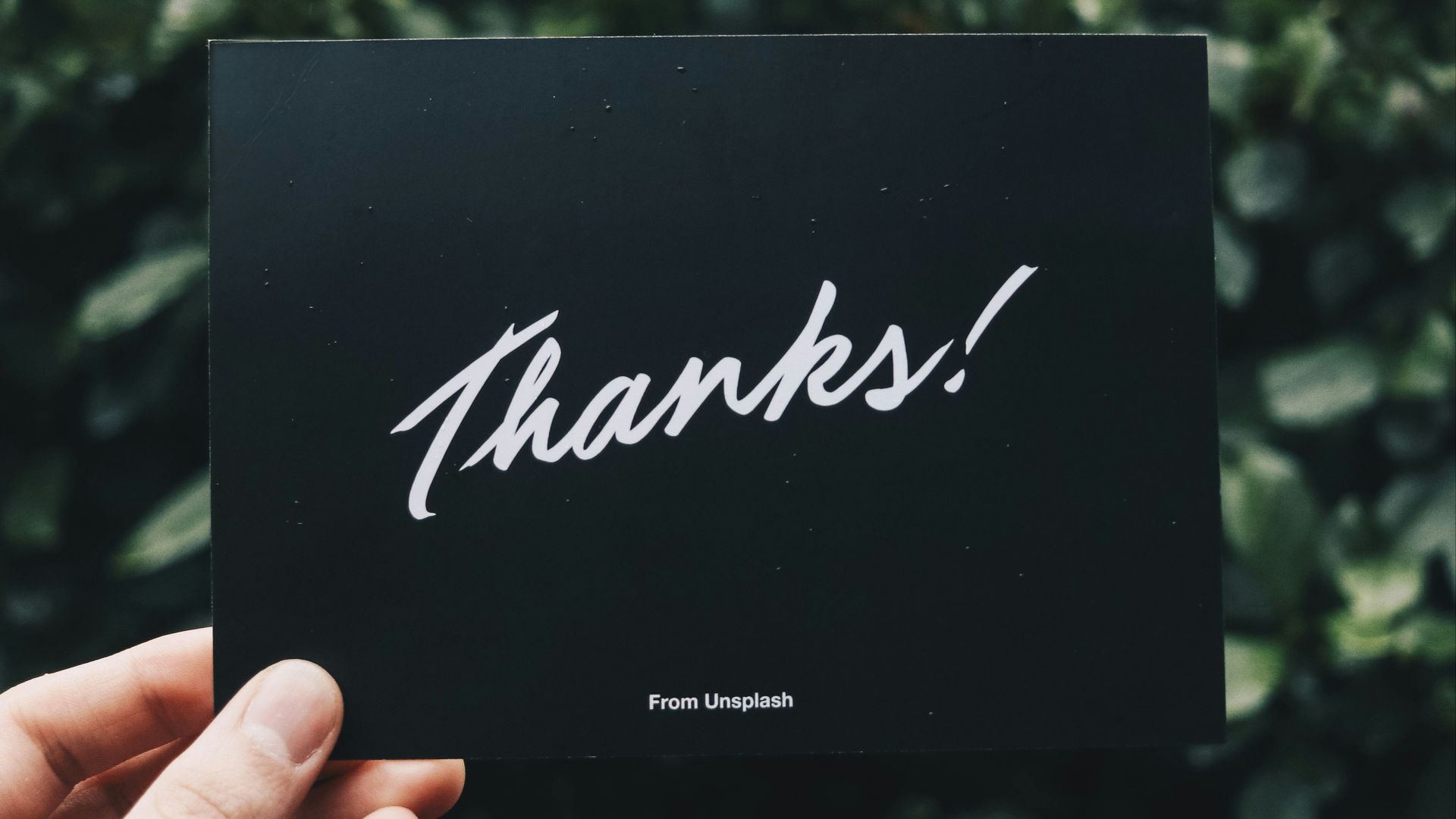 person holding Thanks card