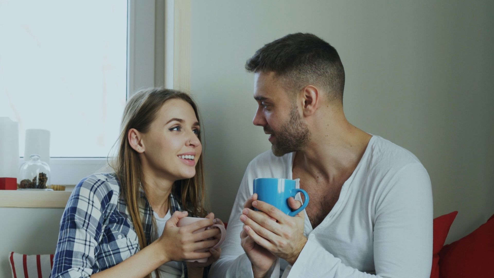 Couple enjoying drinks by the window