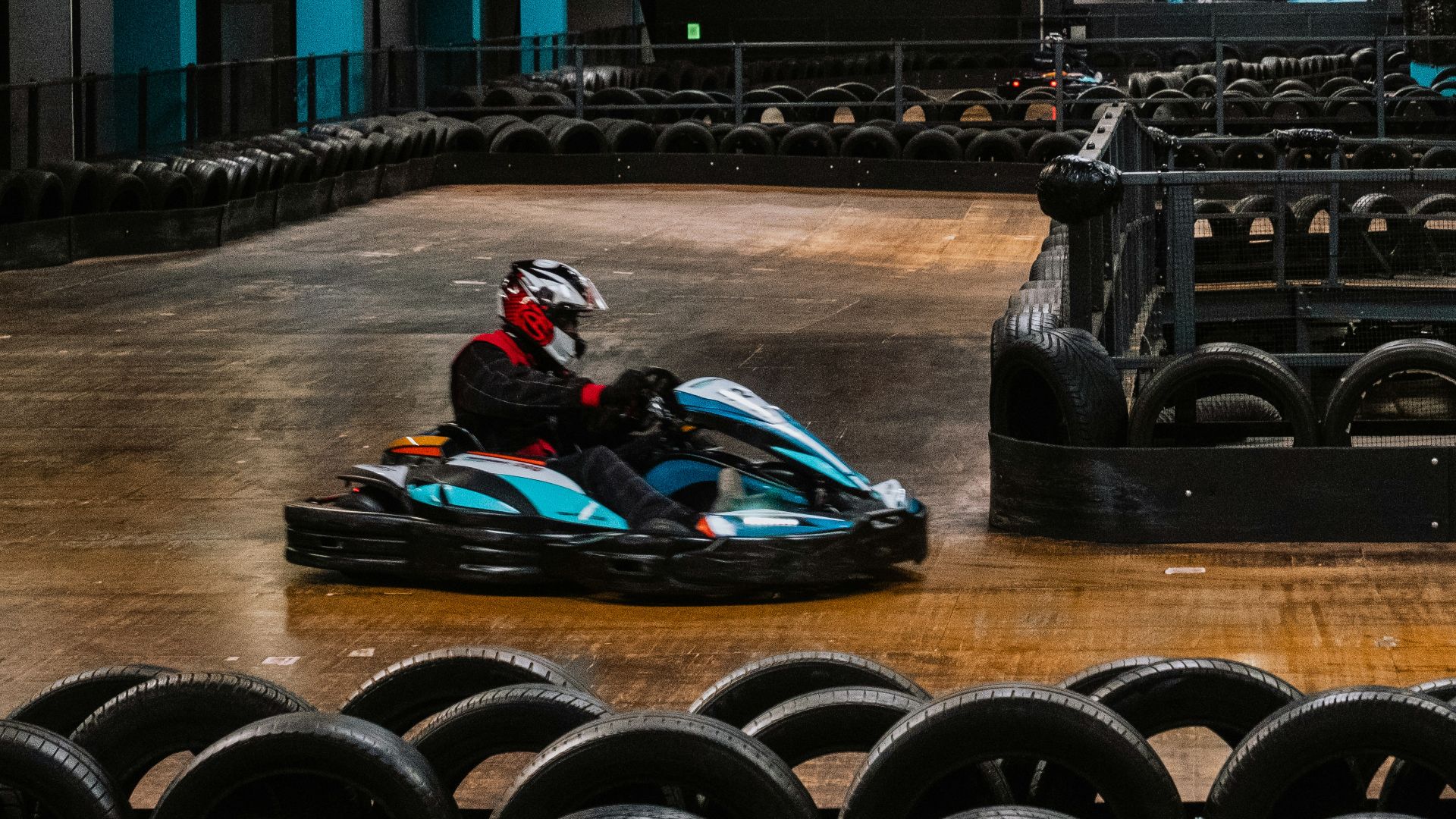 a person riding a go kart in a building