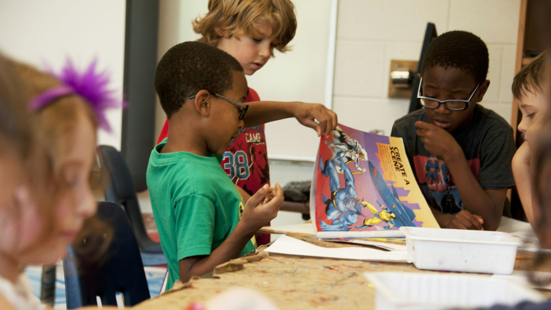 boy in red crew neck t-shirt sitting beside boy in blue crew neck t-shirt