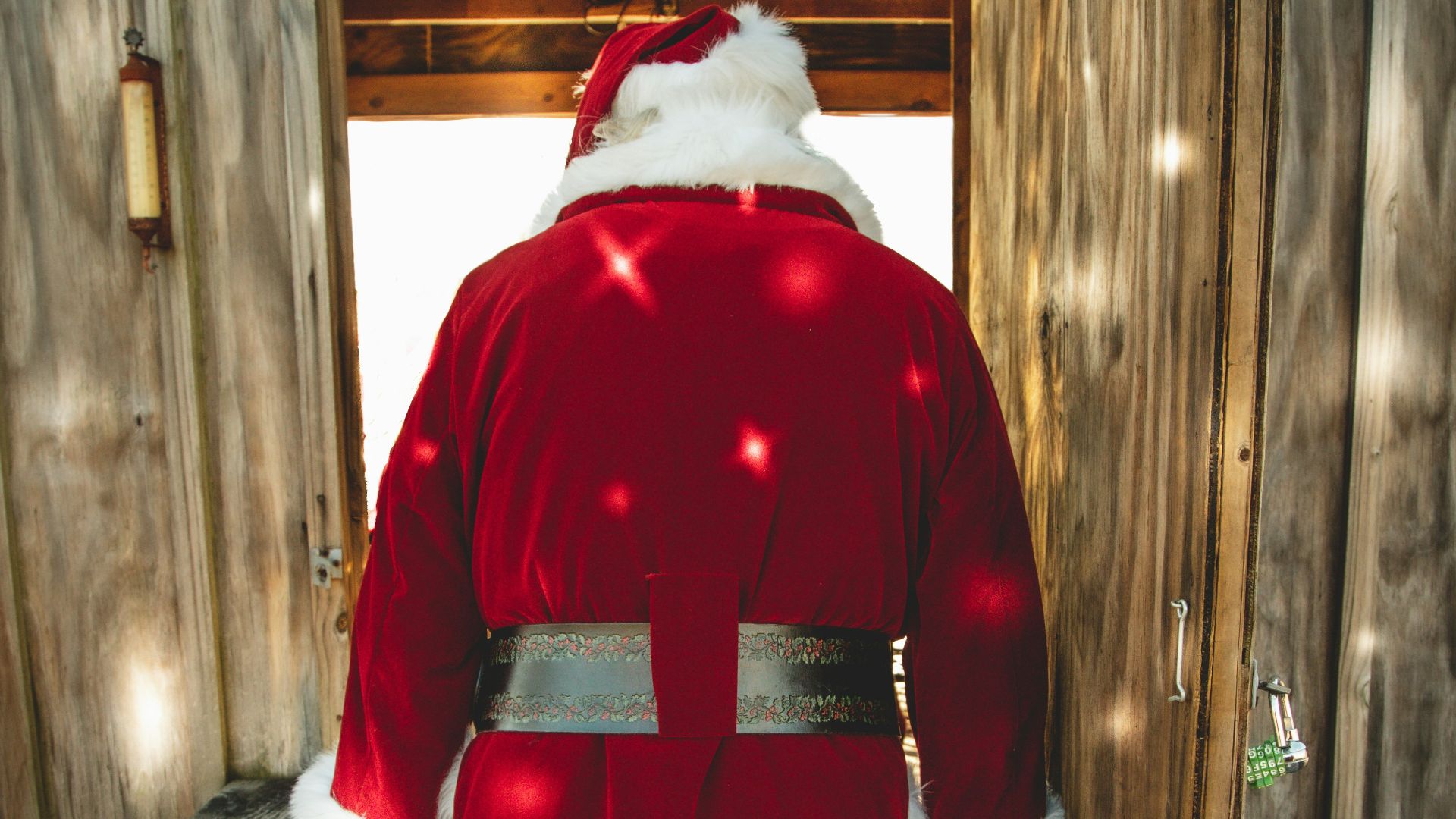 santa claus plush toy on brown wooden bench