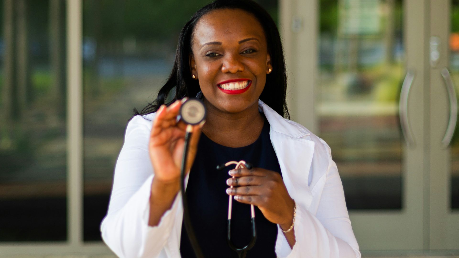 a woman holding a stethoscope in her right hand