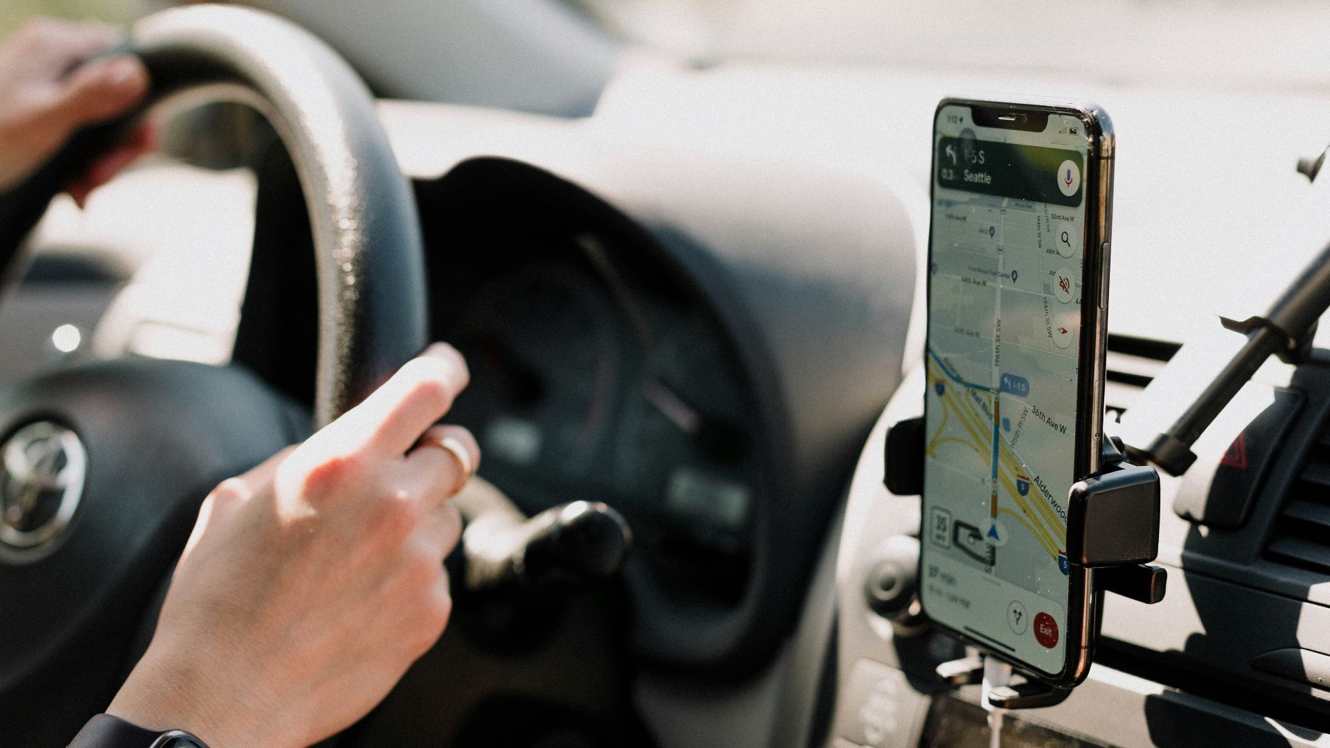 a person using a cell phone while driving a car