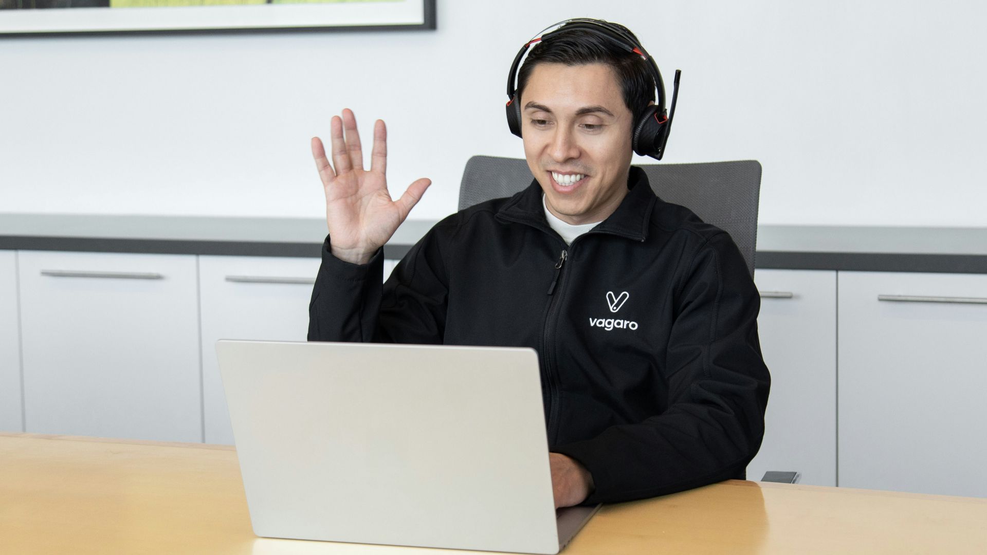 a man wearing headphones sitting in front of a laptop computer