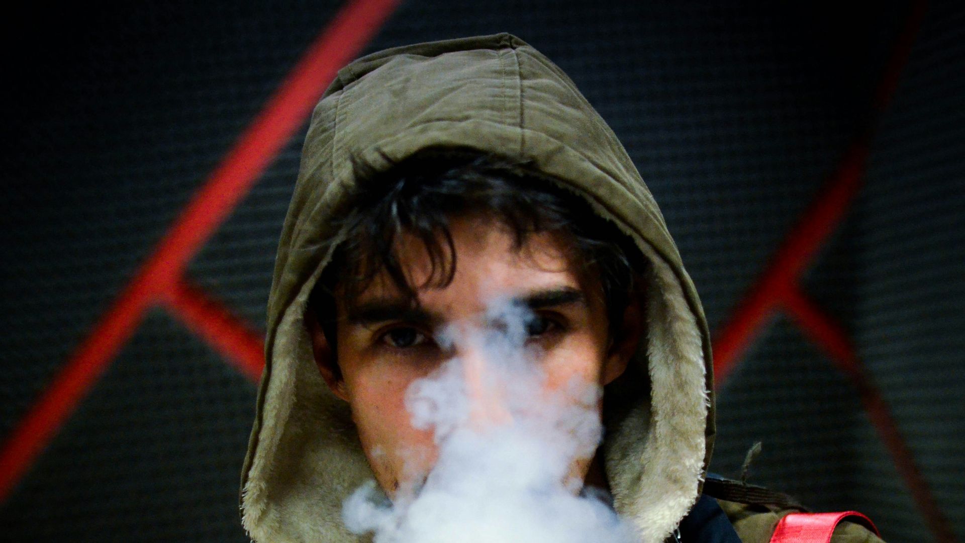 man in hoodie vaping