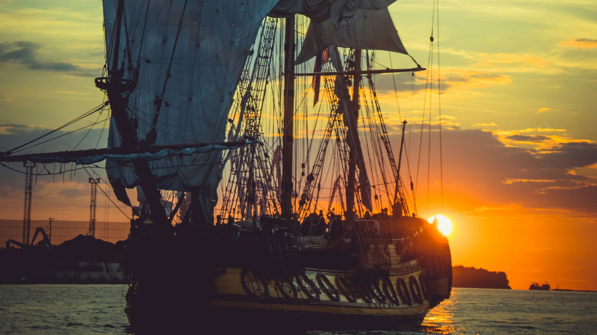 brown sail ship on sea during sunset