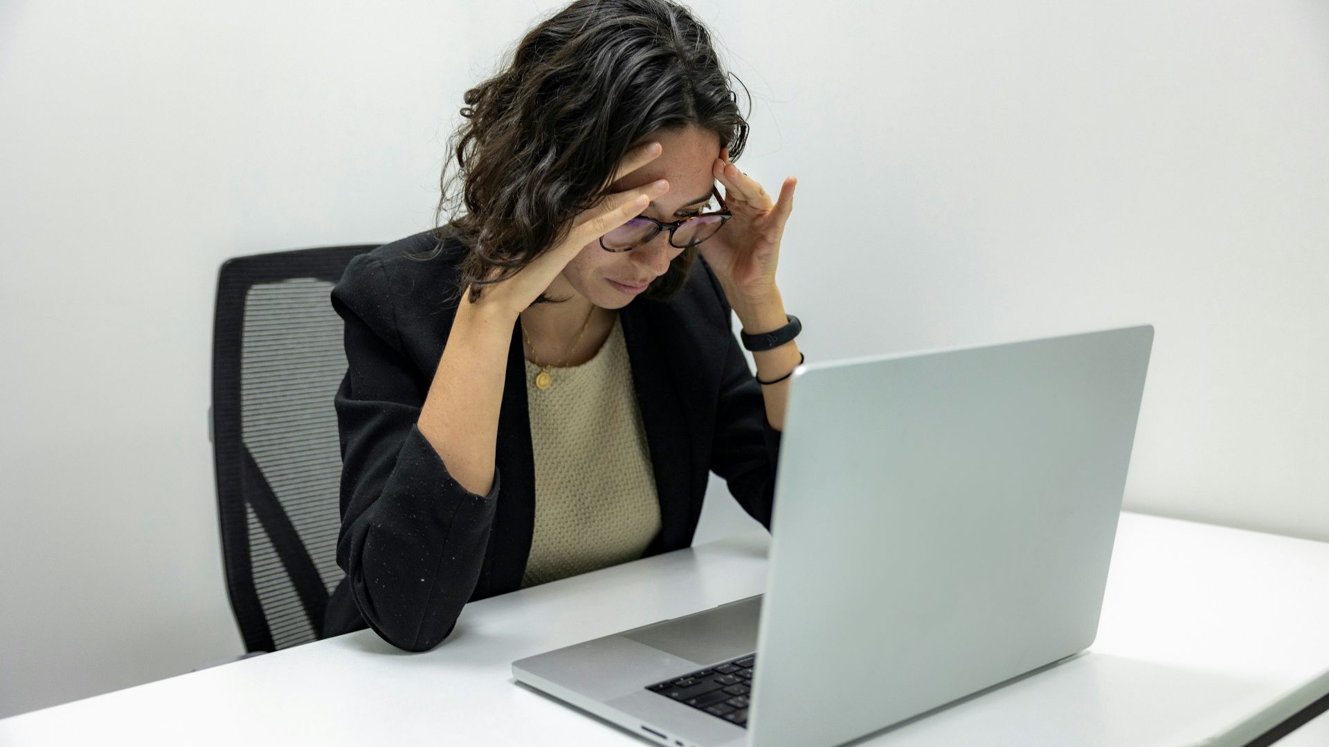 a woman sitting in front of a laptop computer