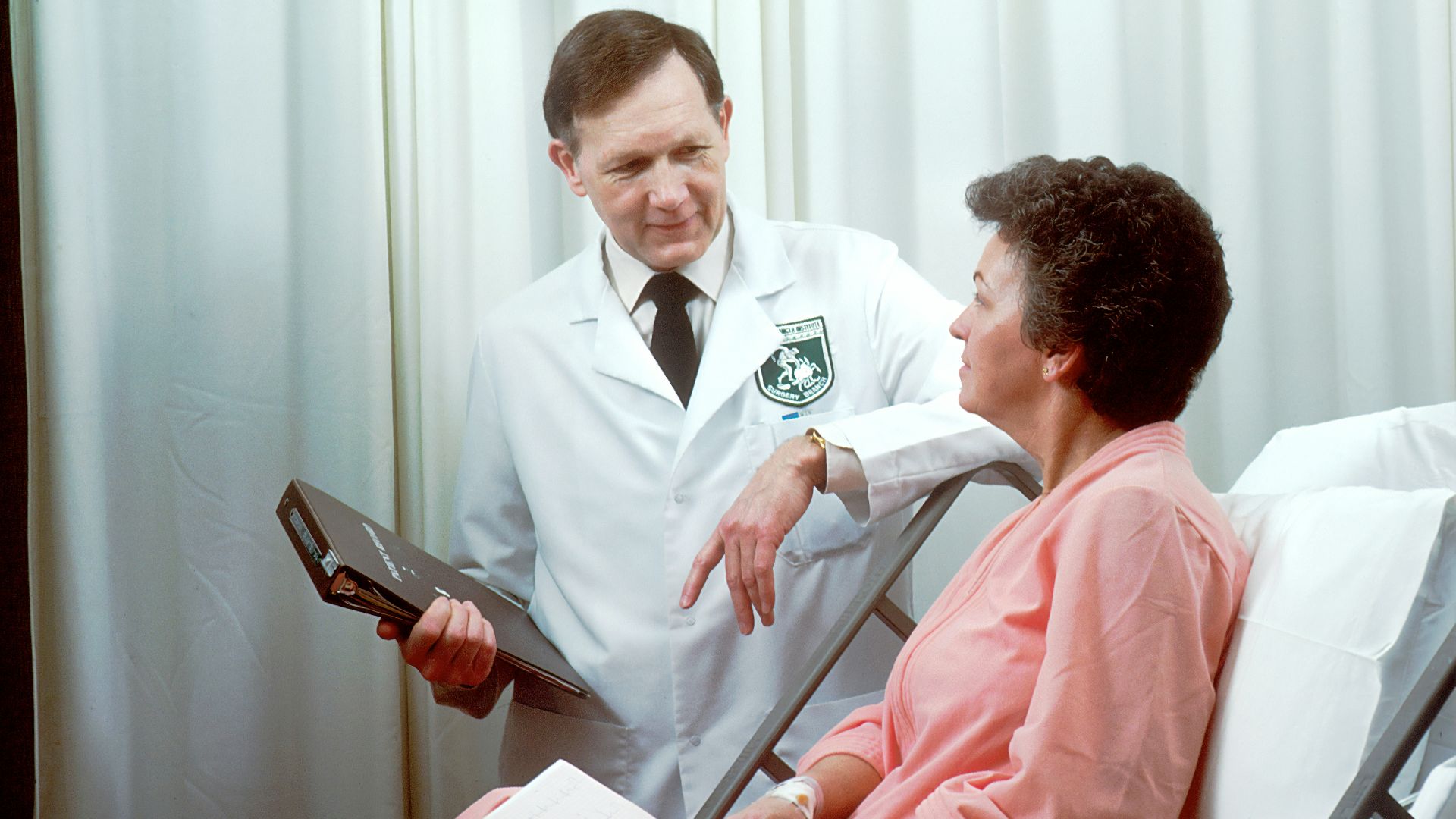 man in white button up shirt holding black tablet computer